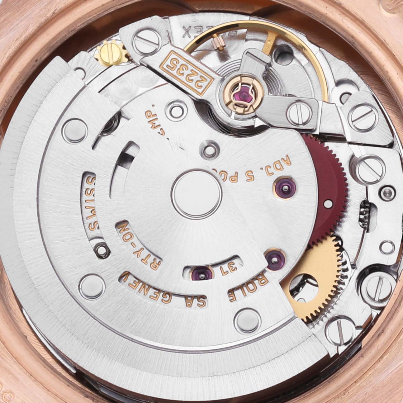 This image shows a close-up of the movement mechanism of a Rolex Datejust watch from above, highlighting gears and inscriptions.