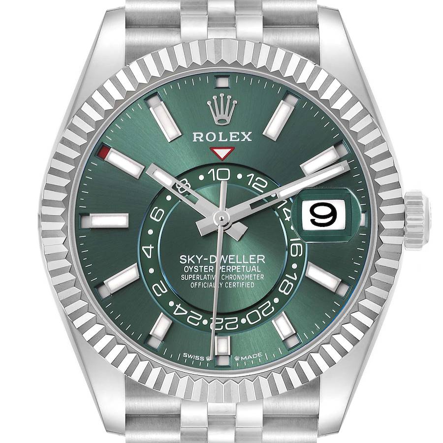 The Rolex Sky-Dweller is shown from a front angle, highlighting the watch face, bezel, and part of the bracelet.