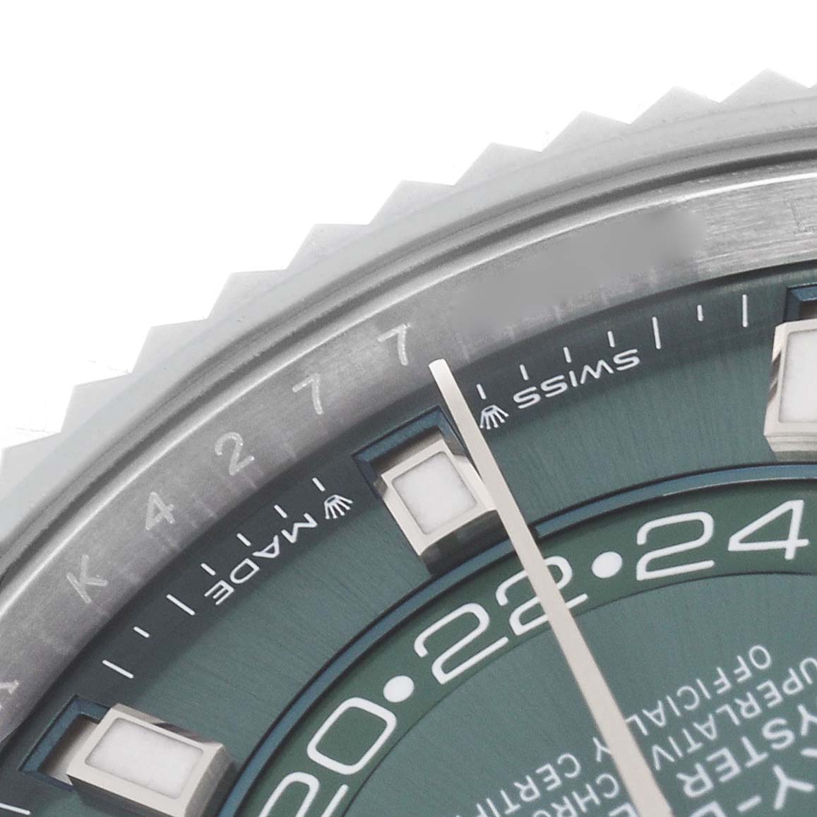 The image shows a close-up of the bezel and dial of the Rolex Sky-Dweller 336934 Men
s Stainless Steel Green Dial 336934 Men
s Stainless Steel Green Dial, highlighting the hour markers and date indicator.