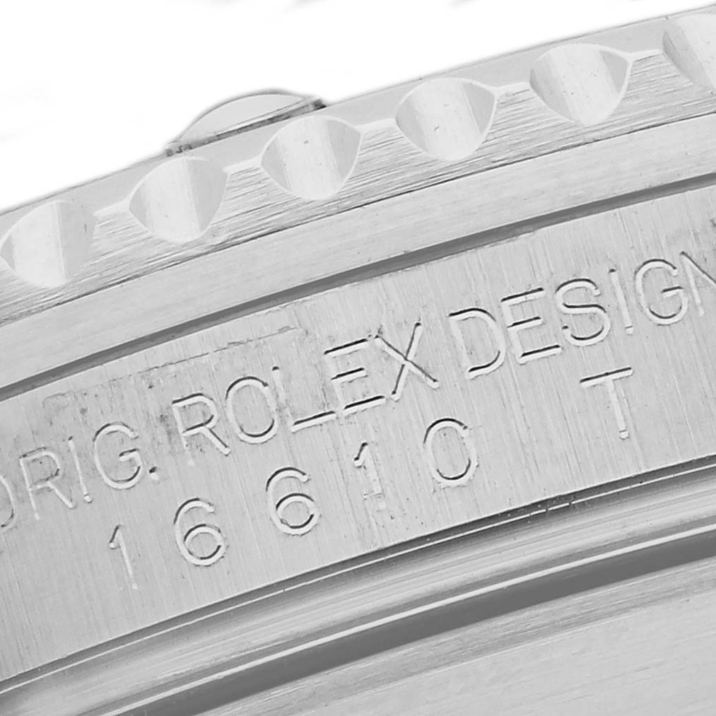 The image shows a close-up of the engraved side of a Rolex Submariner 16610 Men
s Stainless Steel Black Dial 16610 Men
s Stainless Steel Black Dial, focusing on the watch
s model number and bezel.
