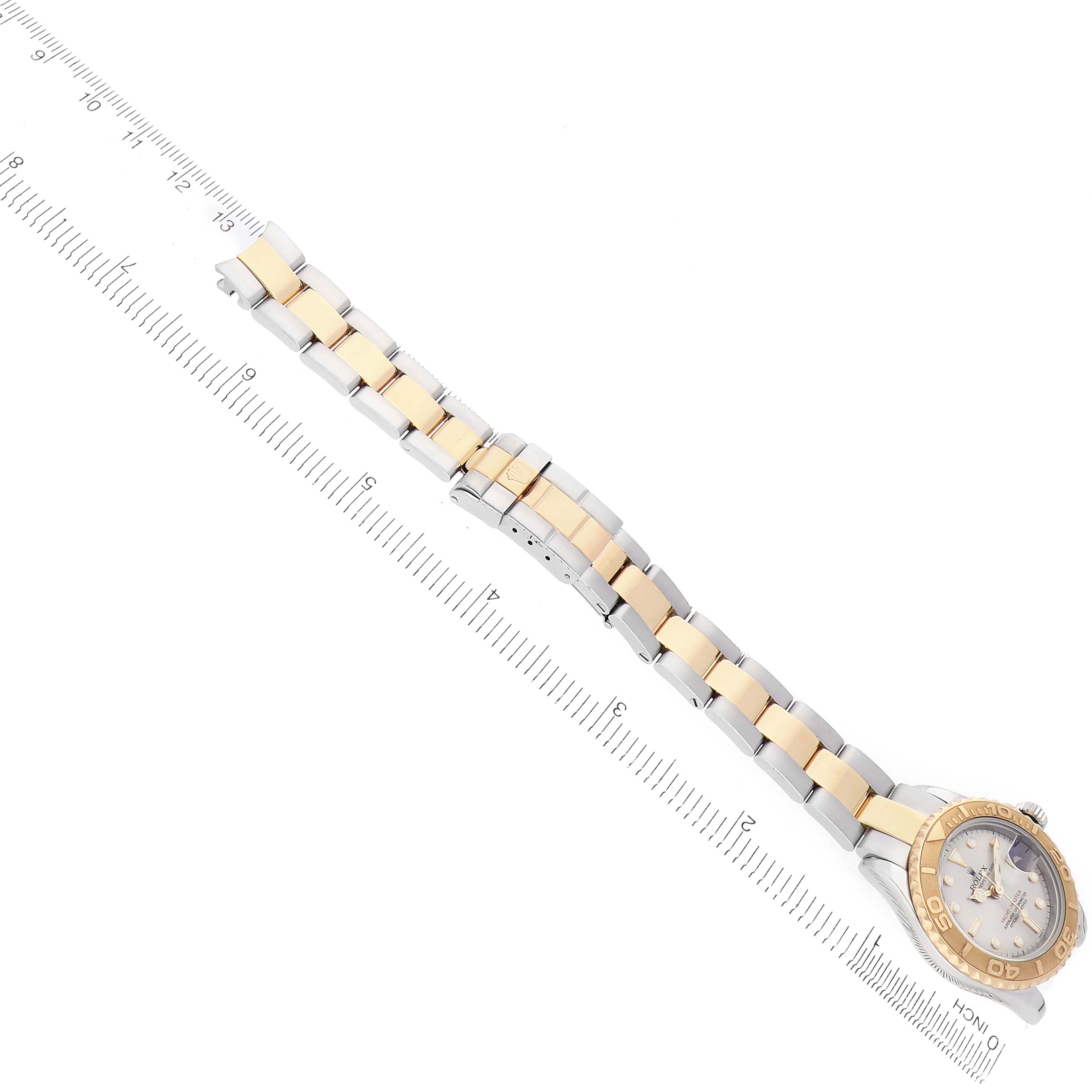 The Rolex Yacht-Master 169623 Women's Steel and Gold (two tone) Silver Dial is shown diagonally with its bracelet and face visible, alongside a ruler for scale.