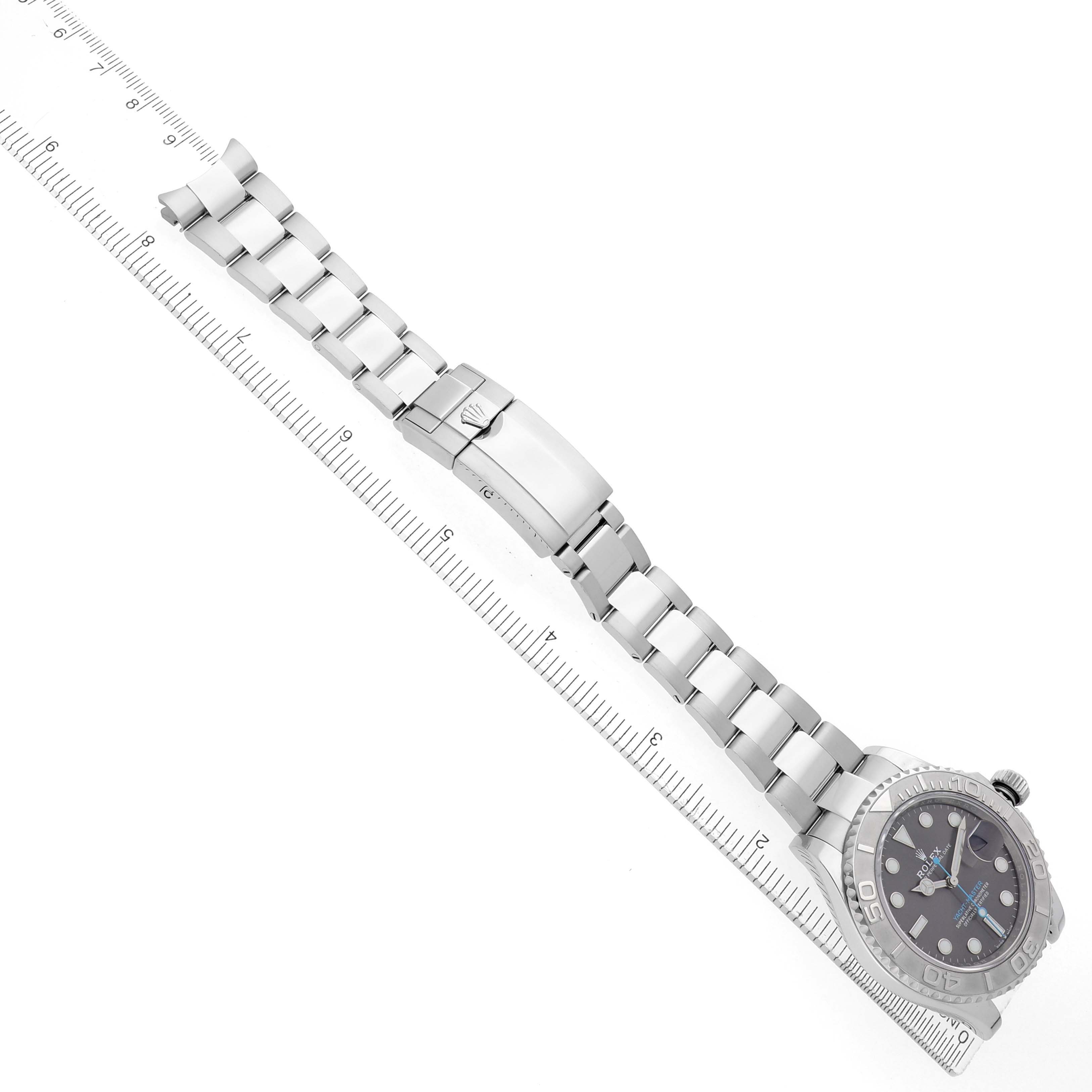 The image shows a Rolex Yacht-Master 126622 Men
s Stainless Steel Silver Dial watch at an angled top-down view, highlighting the bracelet, clasp, and bezel alongside a ruler.
