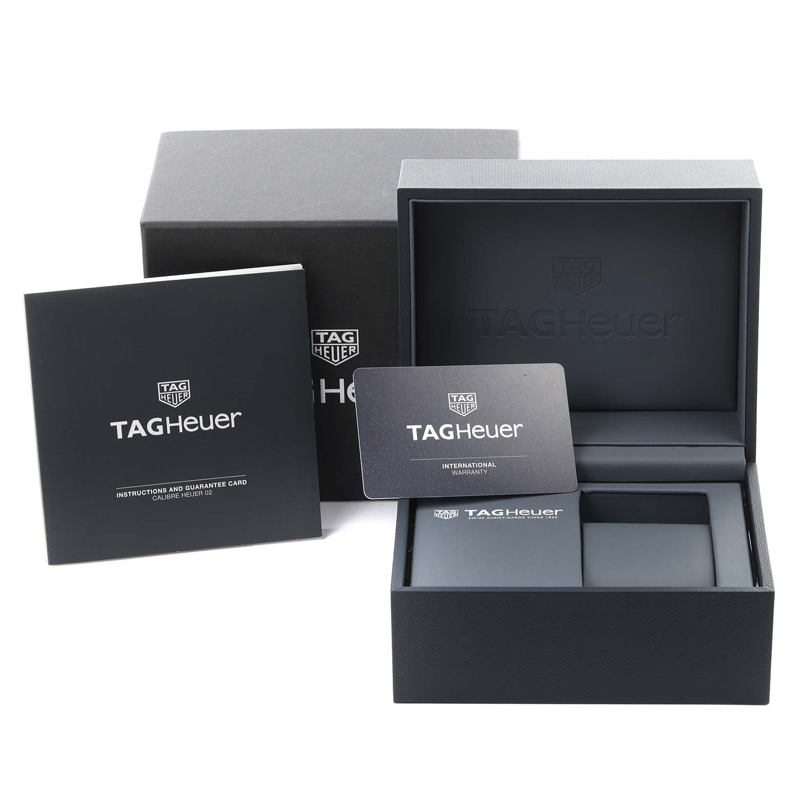 The image shows the packaging, instruction booklet, and warranty card for a Tag Heuer Carrera CBN2A1B.BA0643 Men's Stainless Steel Black Dial CBN2A1B.BA0643 Men's Stainless Steel Black Dial watch.