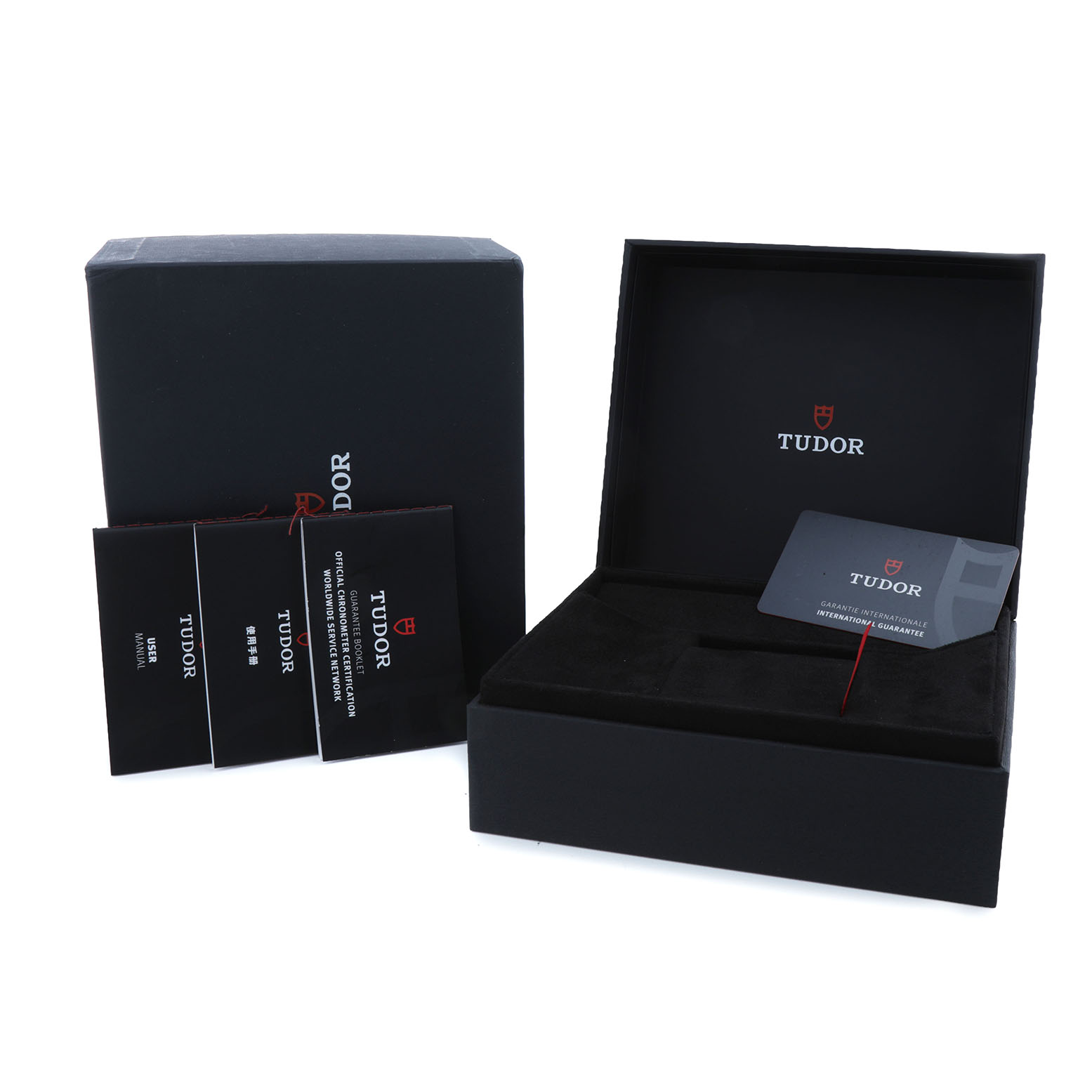The image shows the packaging and accessories for the Tudor Pelagos 25807 Men's Ceramic Blue Dial watch, including manuals and warranty card, viewed from above.