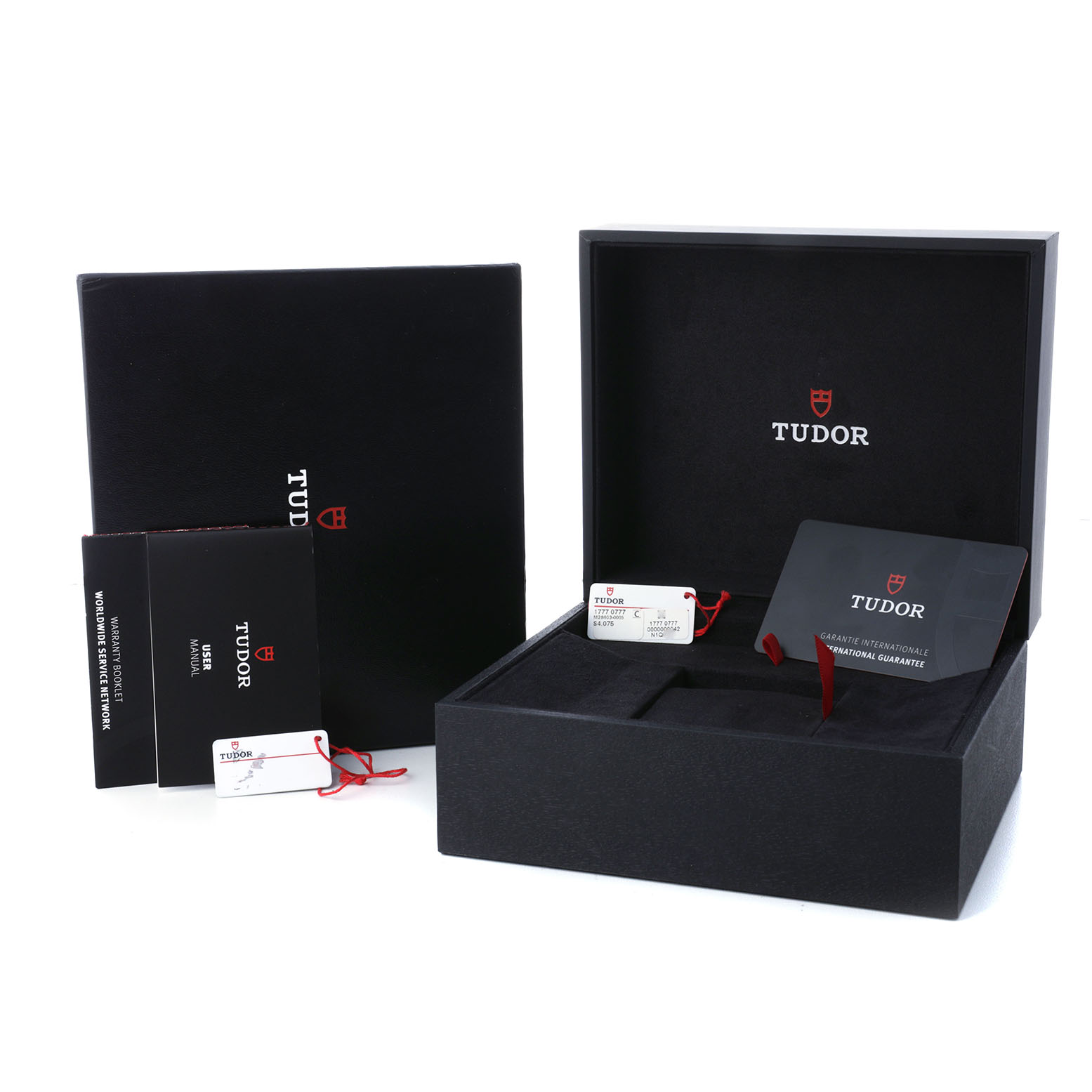 The image shows an open Tudor Royal 28603 Men's Stainless Steel Black Dial watch box with manuals, a warranty card, and tags.