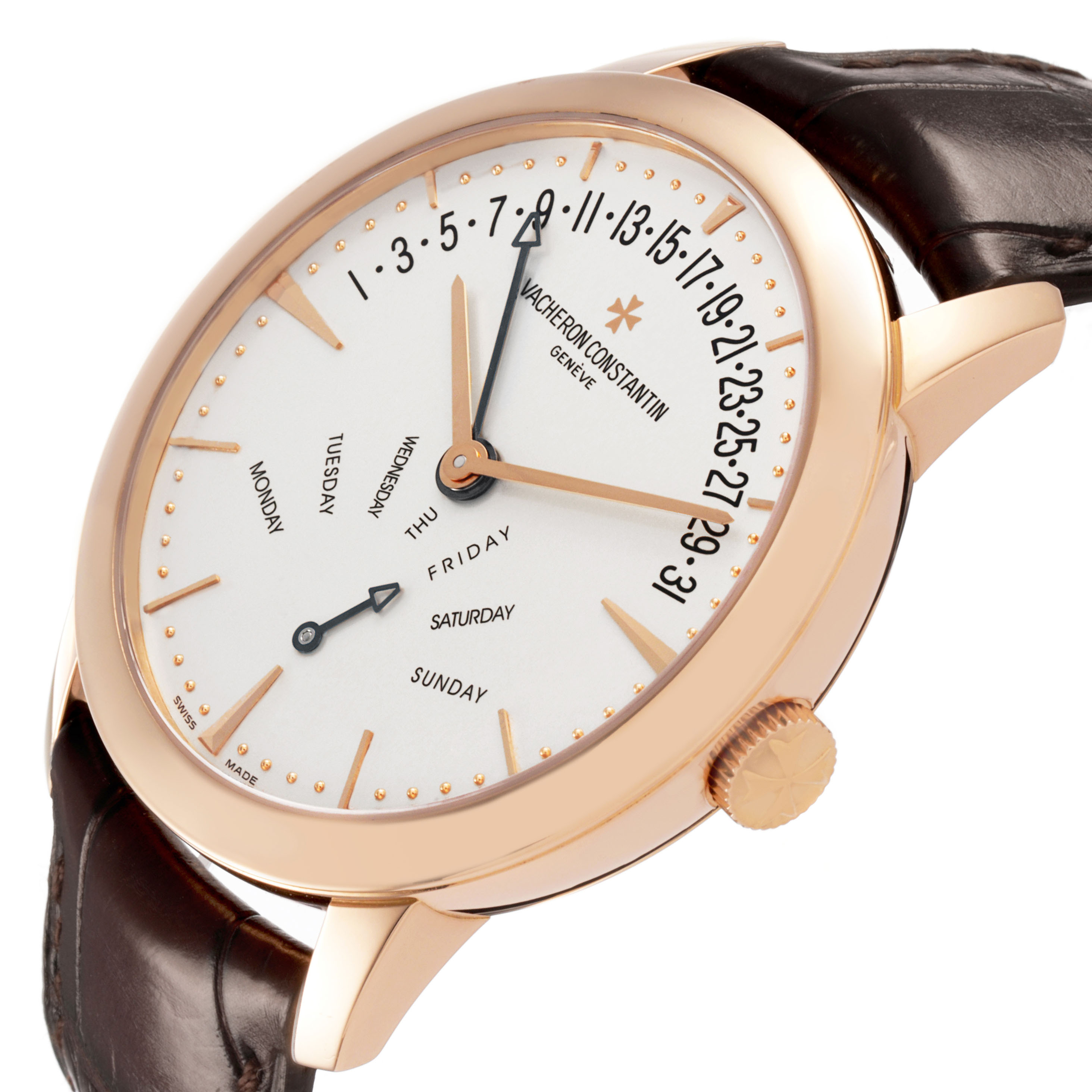 The Patrimony watch by Vacheron Constantin is shown at an angle highlighting the dial, day and date indicators, case, and crown.