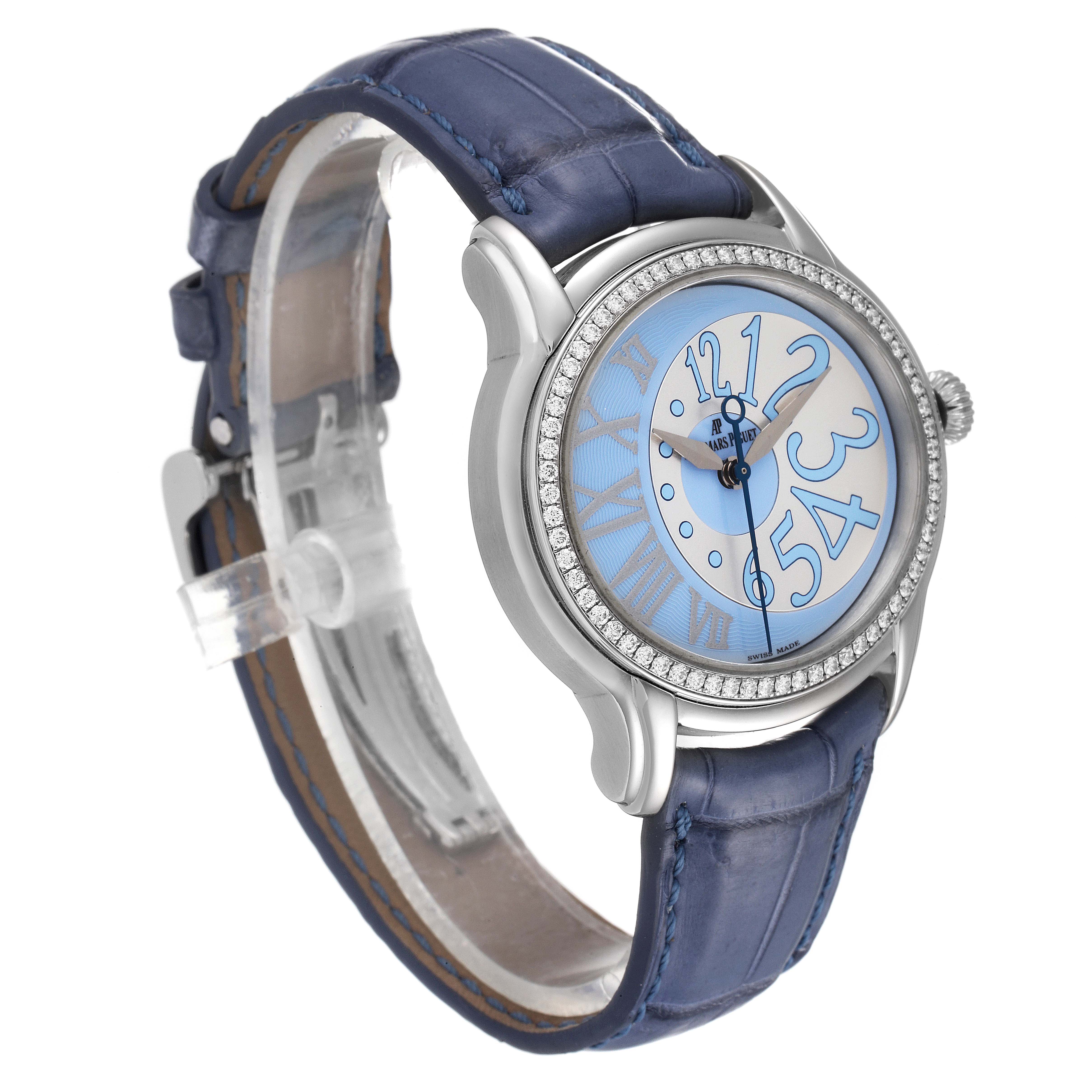 The image shows a side angle of the Audemars Piguet Millenary 77301ST.ZZ.D303CR.01 Women's Stainless Steel Silver Dial 77301ST.ZZ.D303CR.01 Women's Stainless Steel Silver Dial watch, highlighting the blue leather strap, oval case, and detailed face.