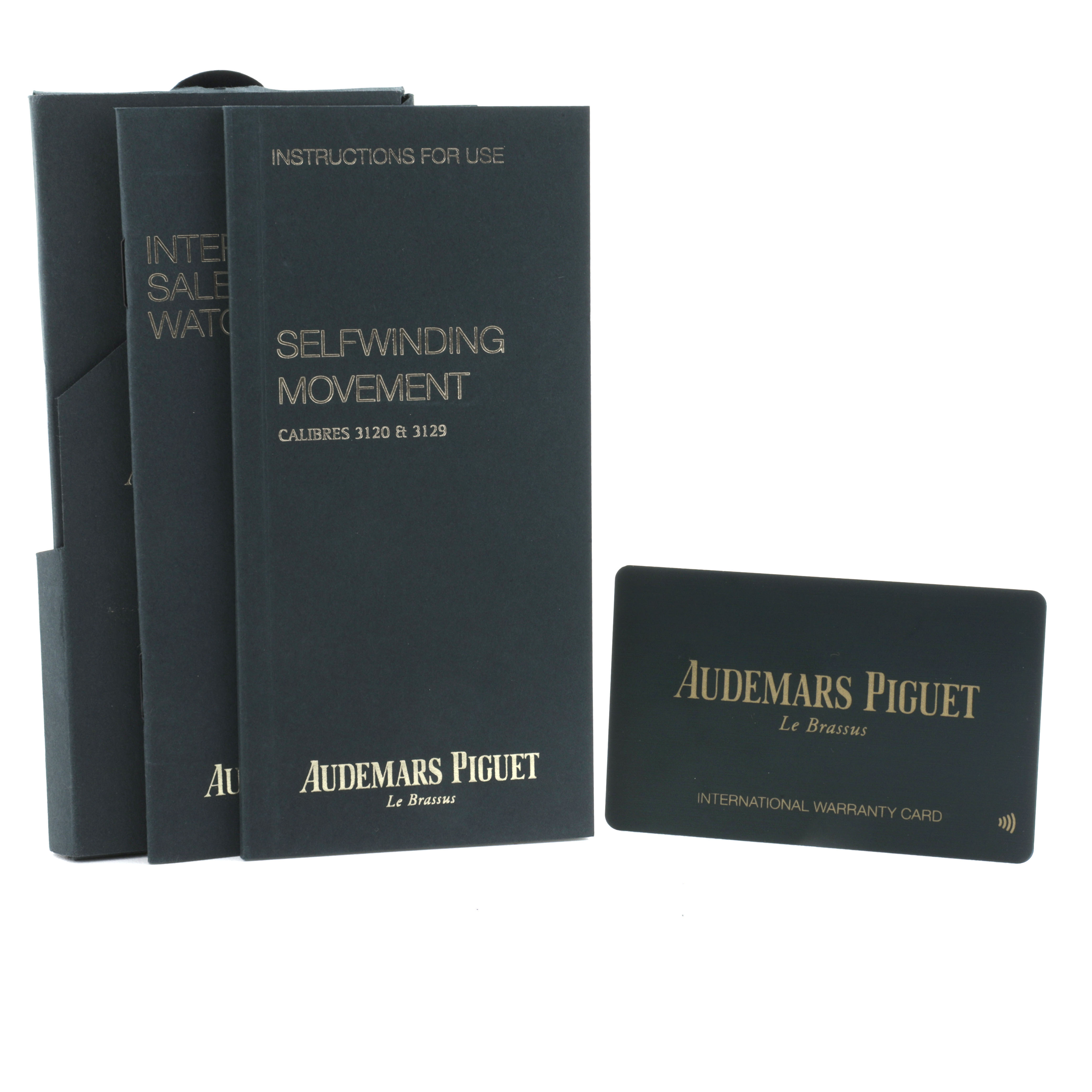 The image shows manuals and a warranty card for an Audemars Piguet Royal Oak 15450ST.OO.1256ST.01 Men's Stainless Steel Silver Dial watch.