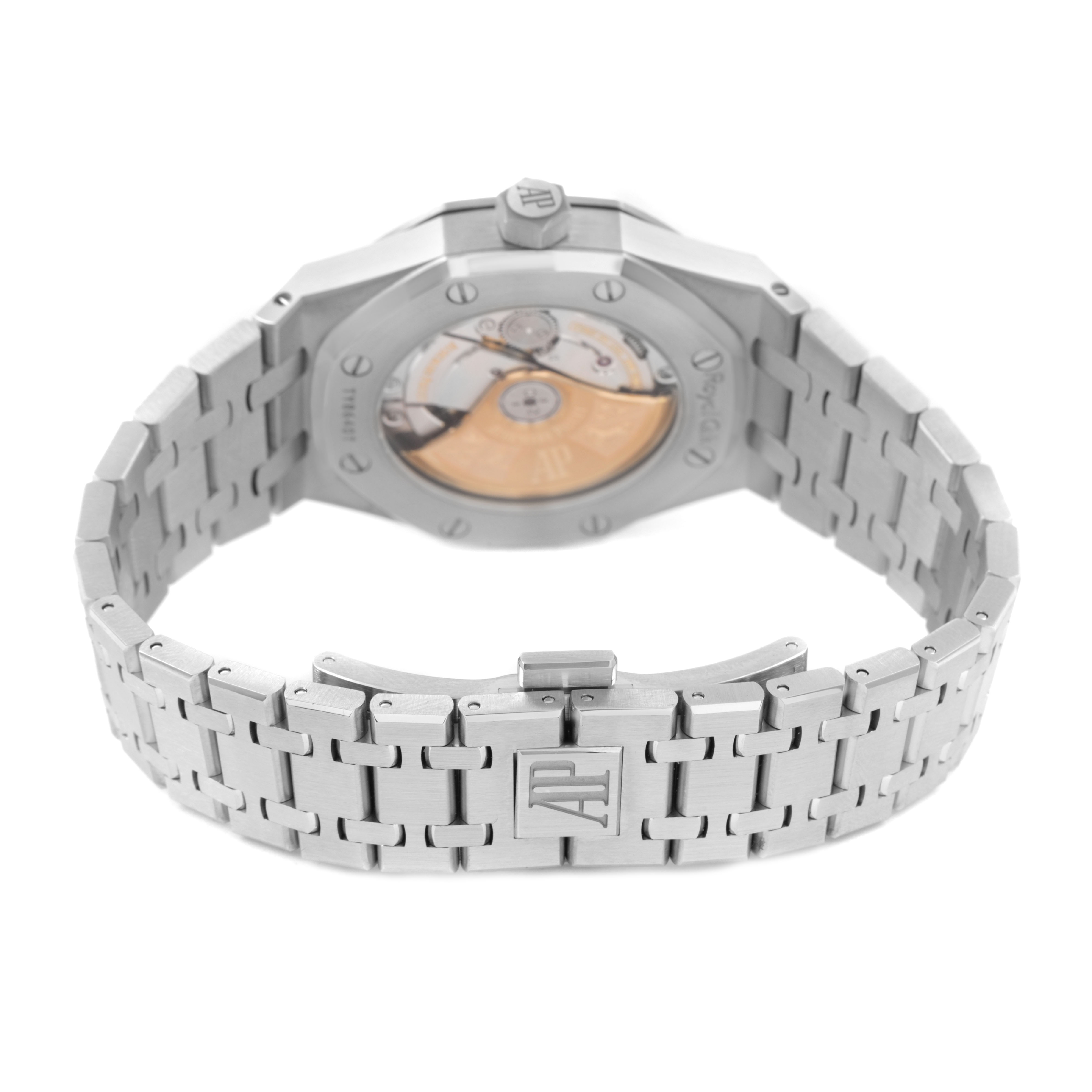 The image shows the back of a Royal Oak by Audemars Piguet, featuring the transparent case back and metal bracelet.
