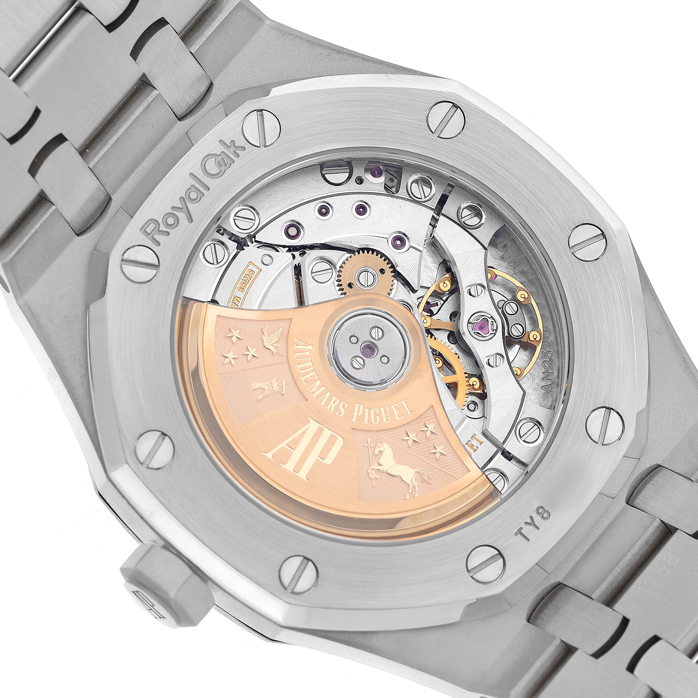 The image shows the back case of a Royal Oak by Audemars Piguet, highlighting its visible movement and intricate mechanical parts.