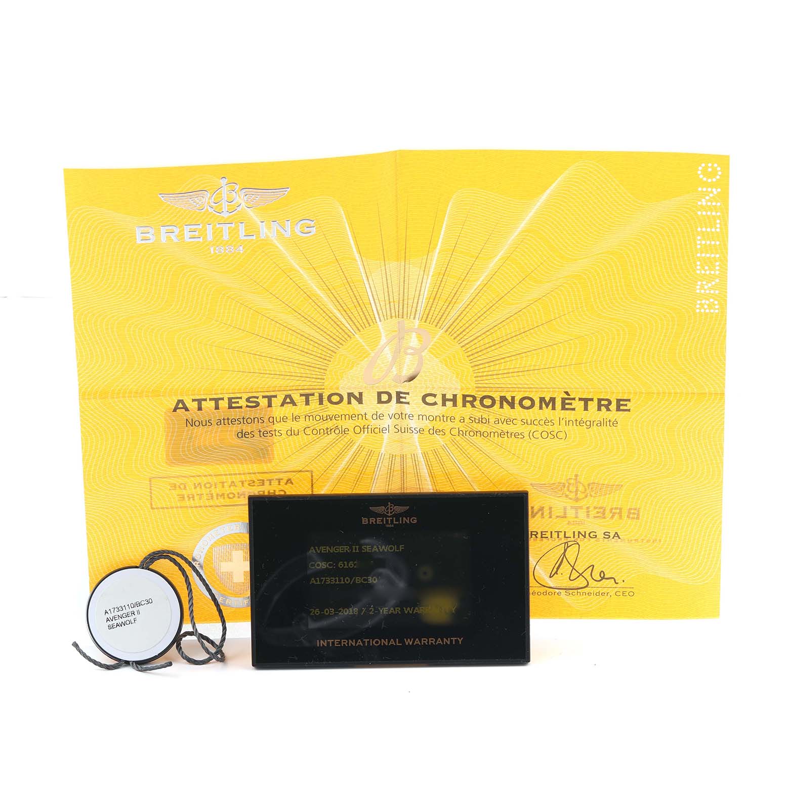 The image shows Breitling Avenger A17331 Men
s Stainless Steel Black Dial accessories: a chronometer certificate, international warranty card, and tag.