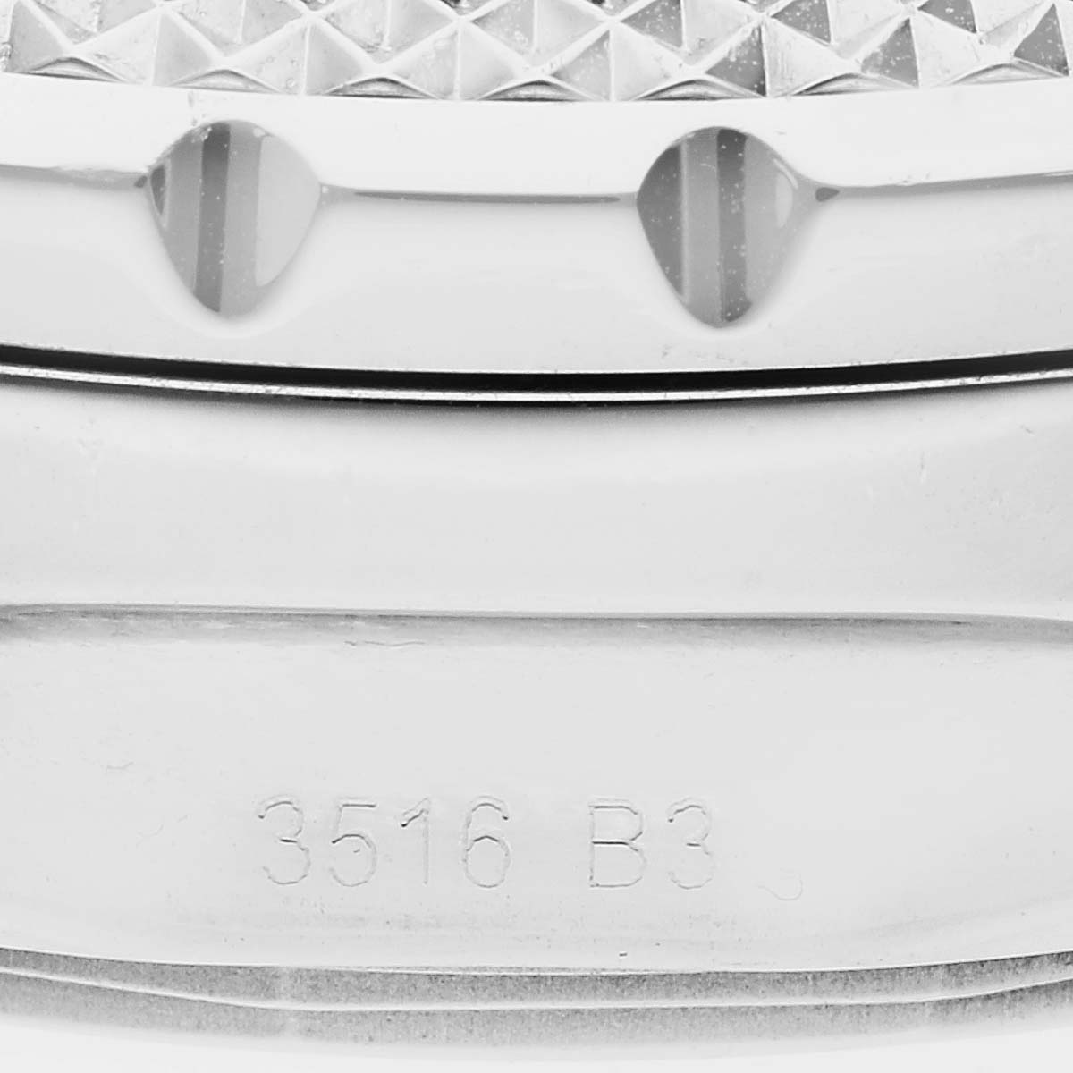 This close-up image shows the serial number and part of the bezel of a Bentley model by Breitling.
