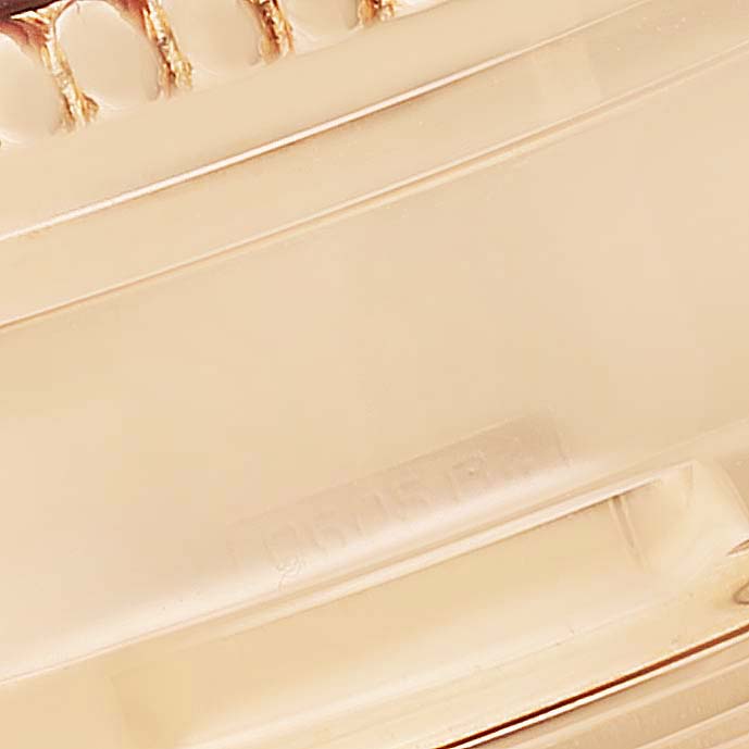 The image shows a close-up of a gear-like part, likely from the strap or case of the Breitling Navitimer H19350 Men's Rose Gold Silver Dial H19350 Men's Rose Gold Silver Dial watch.