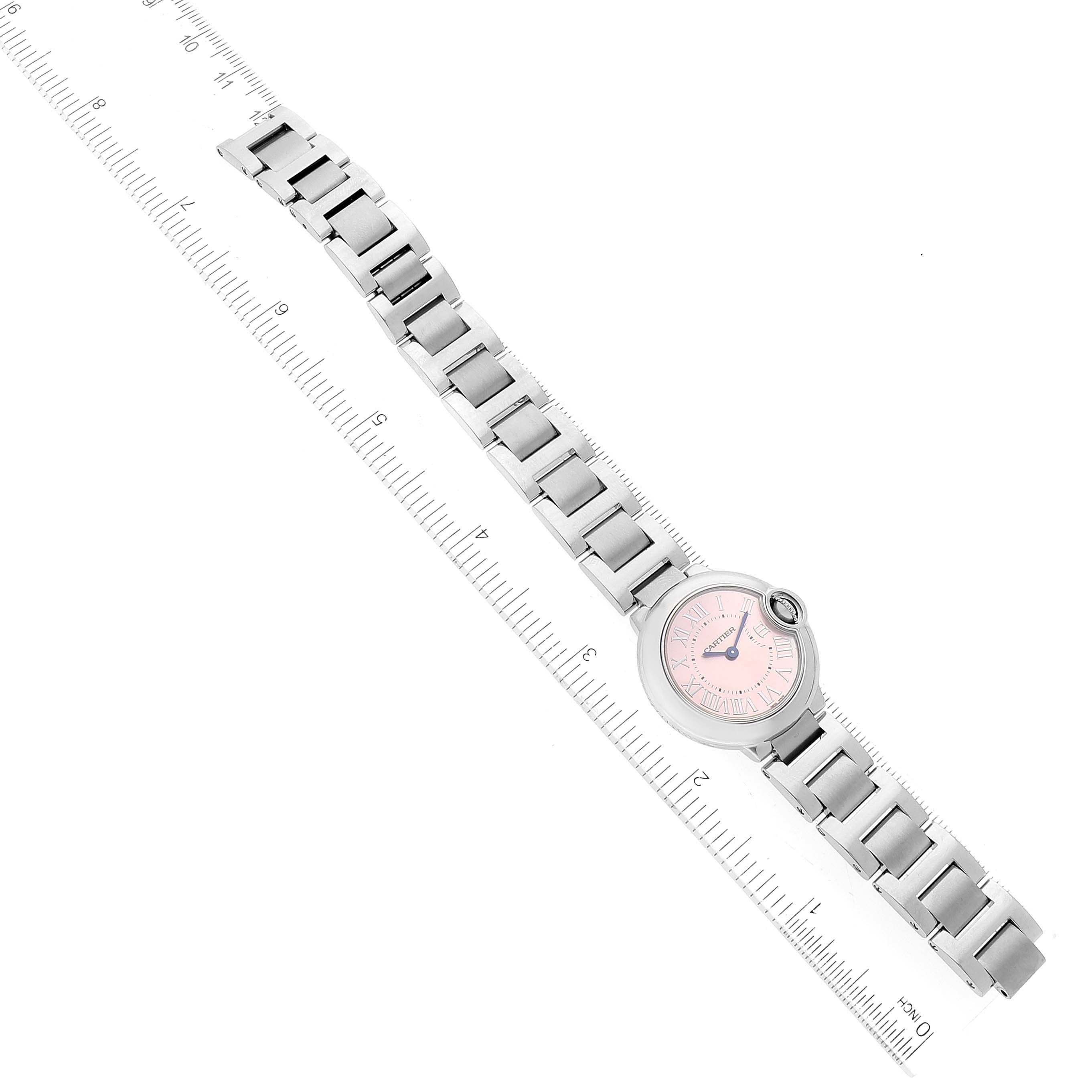 The image shows a top-down view of a Ballon Bleu model by Cartier, highlighting the watch face, bracelet, and clasp.