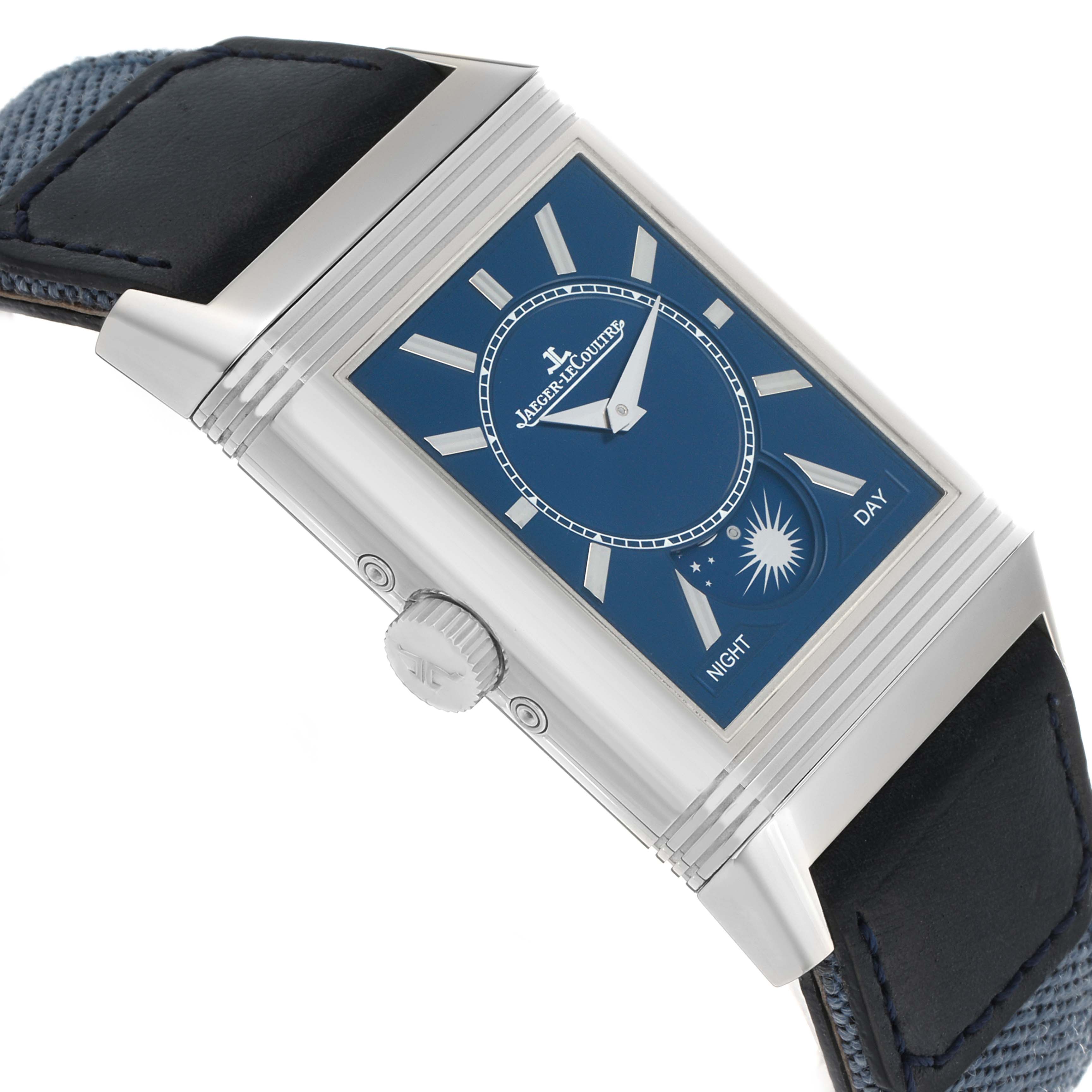 The Jaeger-LeCoultre Reverso watch is angled to show its face and crown, highlighting the blue dial and silver indices.