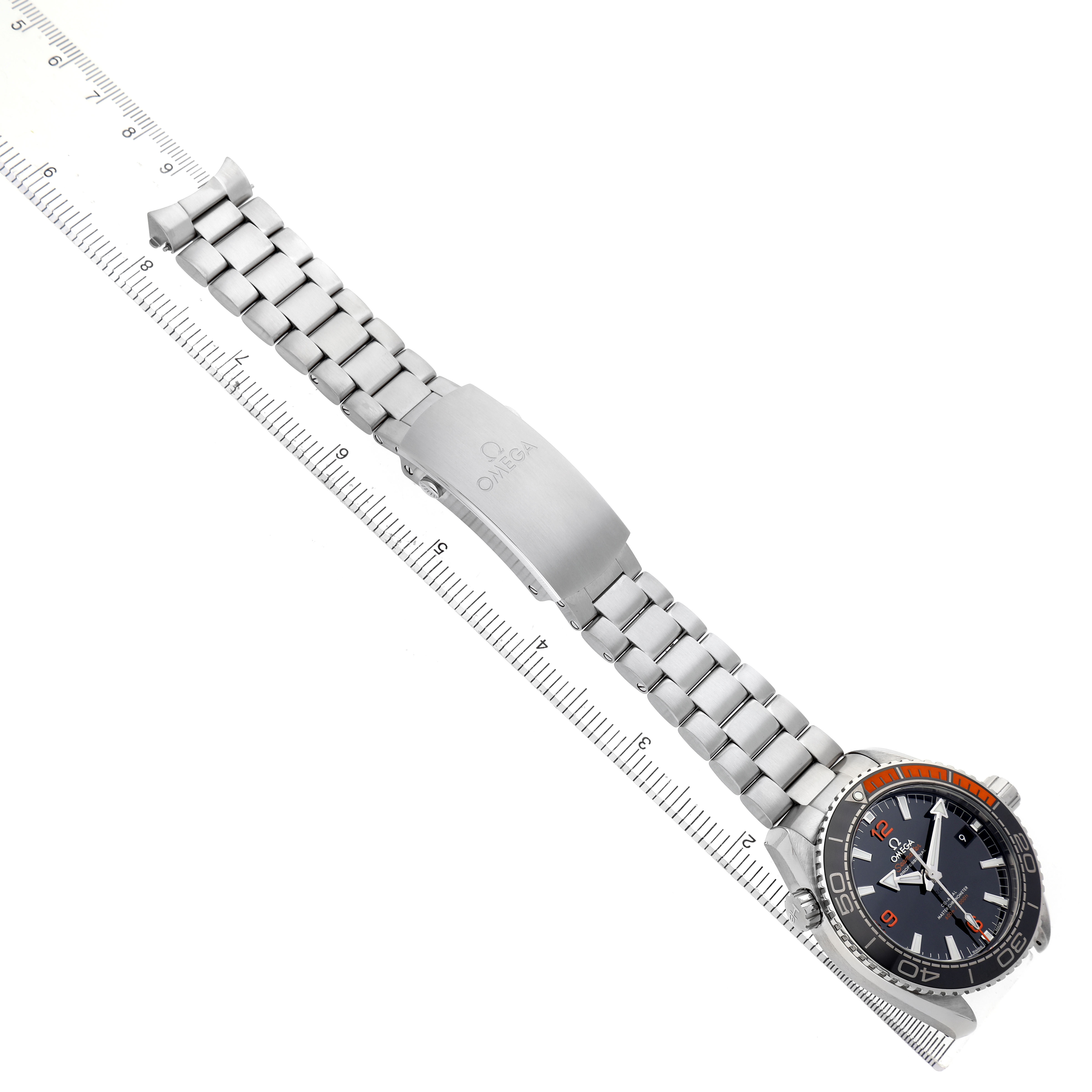 The Omega Seamaster 215.32.44.21.01.001 Men's Stainless Steel Black Dial watch is shown flat, displaying the bracelet, clasp, and face, with a ruler for size reference.