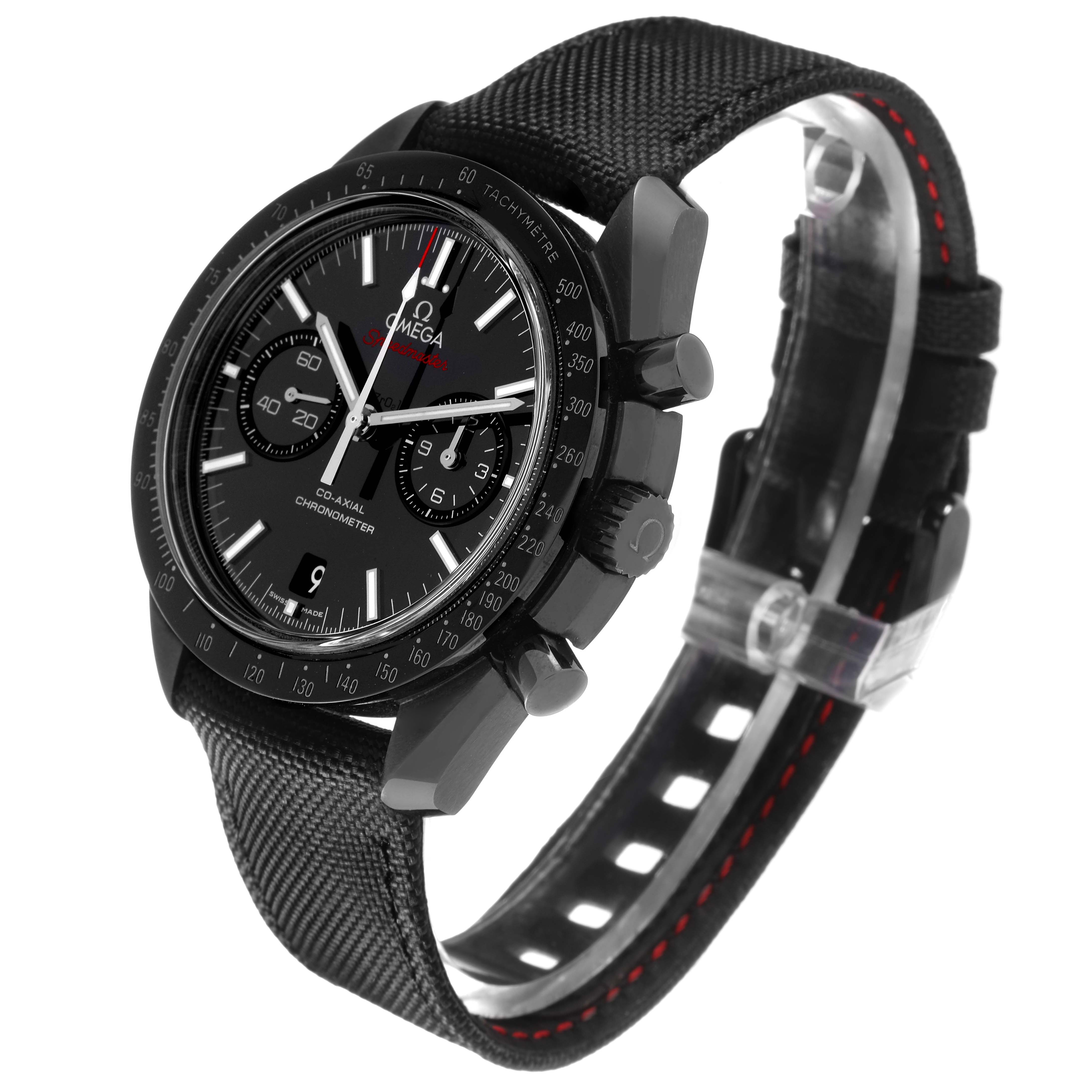 The Omega Speedmaster 311.92.44.51.01.003 Men
s Ceramic Black Dial watch is shown at a three-quarter angle, highlighting its black dial, bezel, and fabric strap with red stitching.