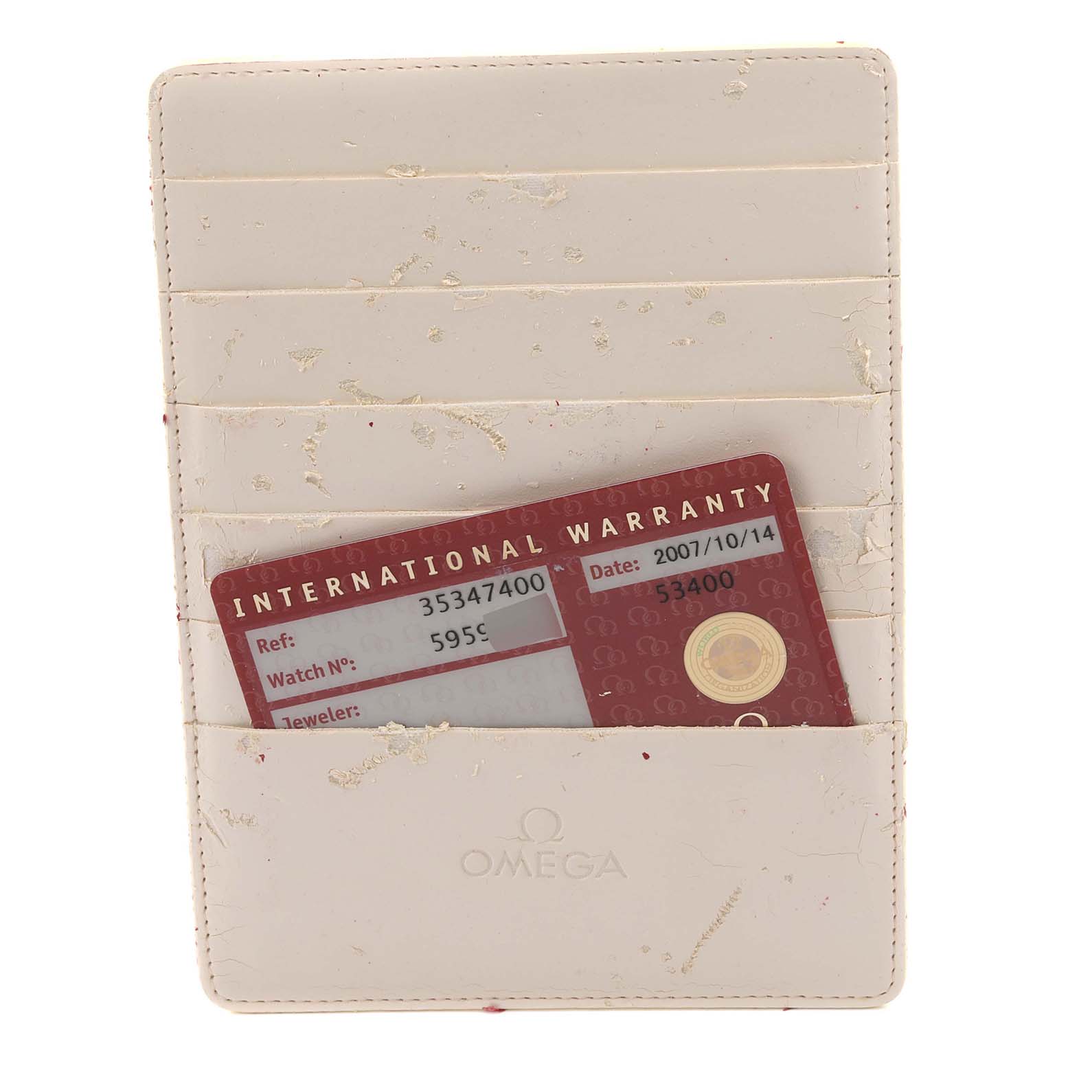 The image shows an Omega Speedmaster 3534.74.00 Men's Stainless Steel Mother of Pearl Dial 3534.74.00 Men's Stainless Steel Mother of Pearl Dial's warranty card in a beige cardholder, viewed from above.