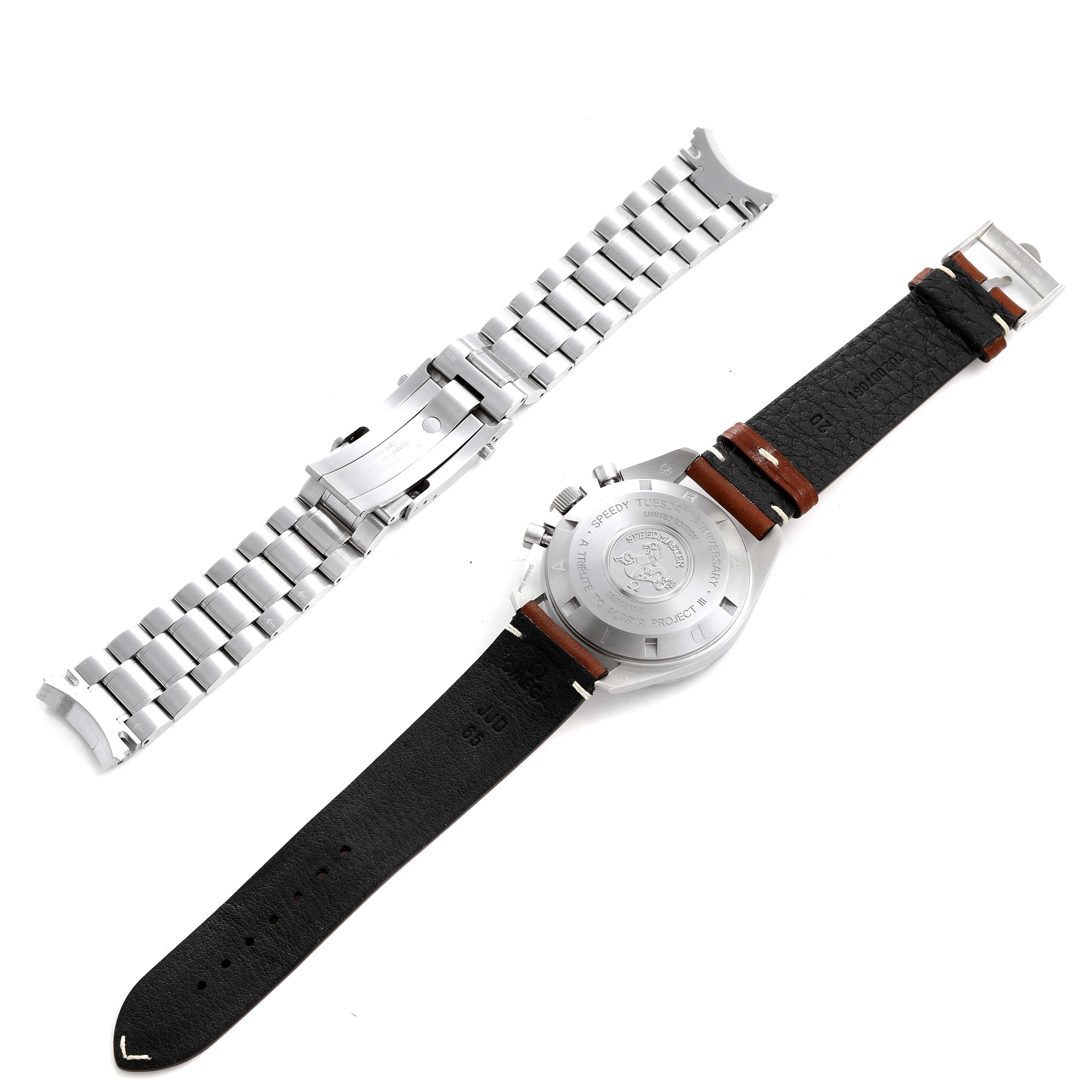 The image shows the back of an Omega Speedmaster 311.32.42.30.01.001 Men's Steel and Gold (two tone)  311.32.42.30.01.001 Men's Steel and Gold (two tone)  watch with a leather strap and a separate metal bracelet.