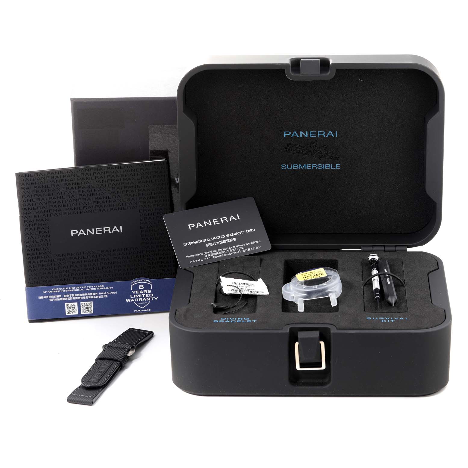 The image shows the Panerai Submersible PAM01223 Men
s Stainless Steel White Dial PAM01223 Men
s Stainless Steel White Dial watch box and accessories from a front angle, including a warranty card, extra strap, and toolkit.