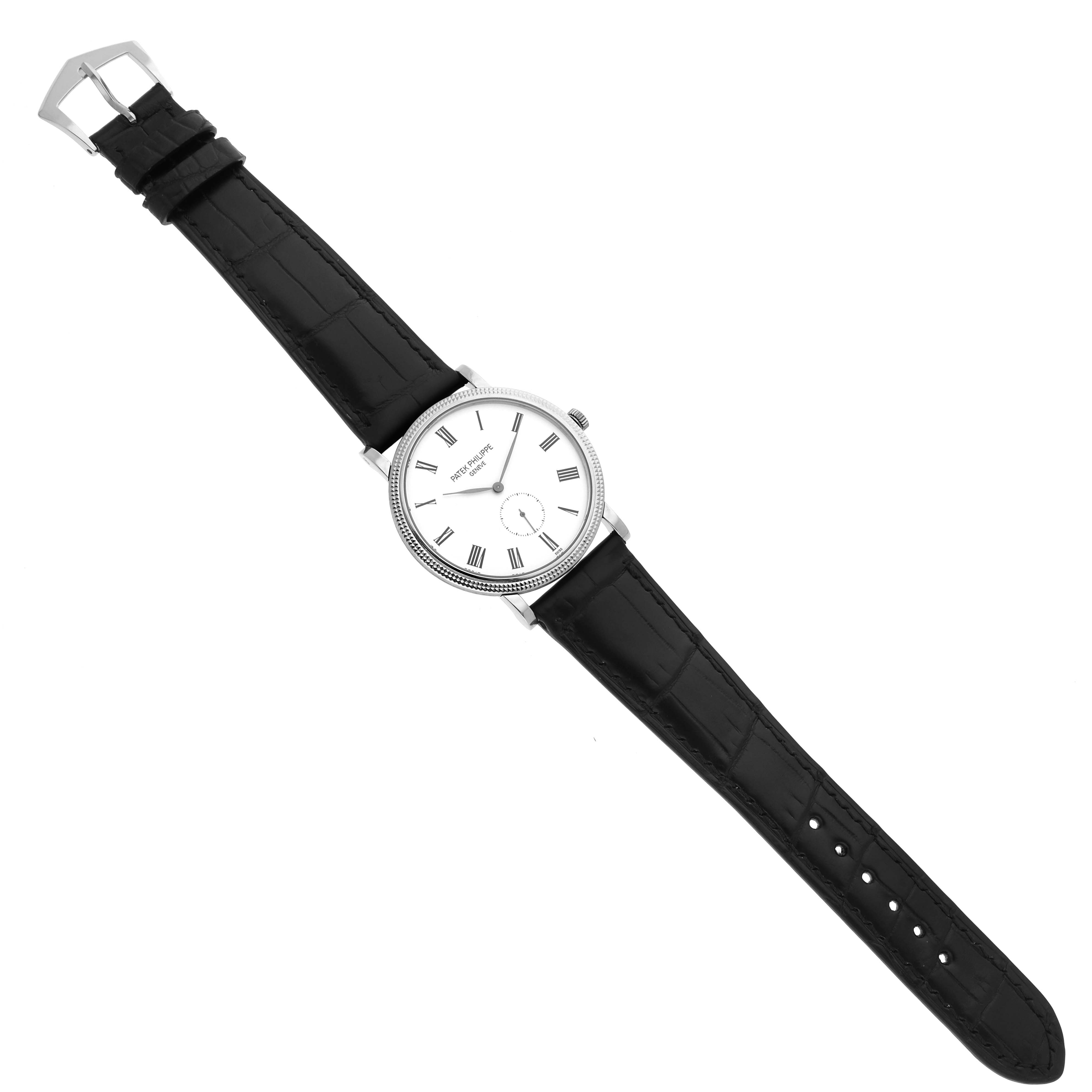 The Patek Philippe Calatrava 5119G Men
s White Gold White Dial watch is shown from an overhead angle, displaying its face, strap, and buckle.