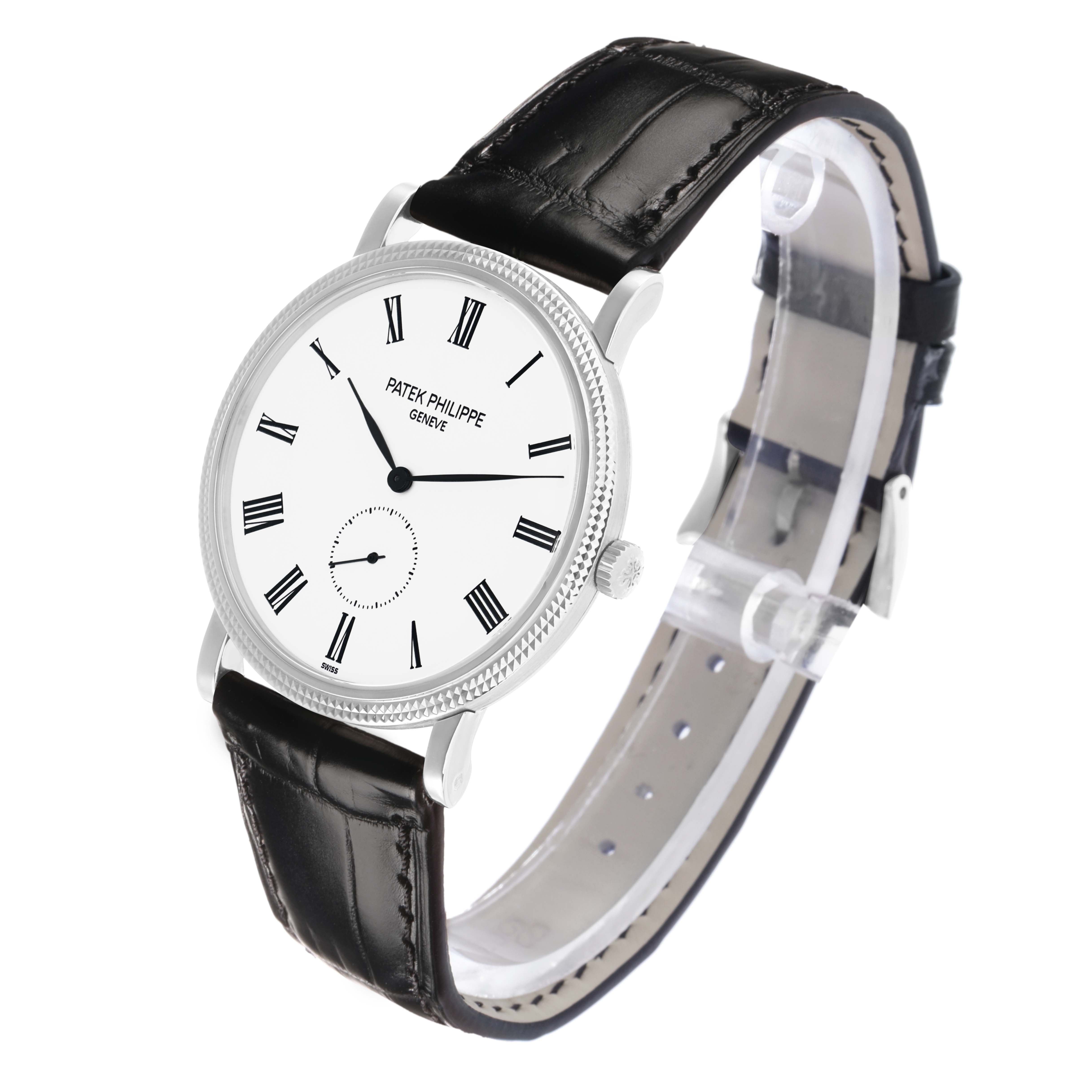 The Patek Philippe Calatrava 5119G Men
s White Gold White Dial watch is shown at an angle highlighting the face, bezel, crown, and leather strap.