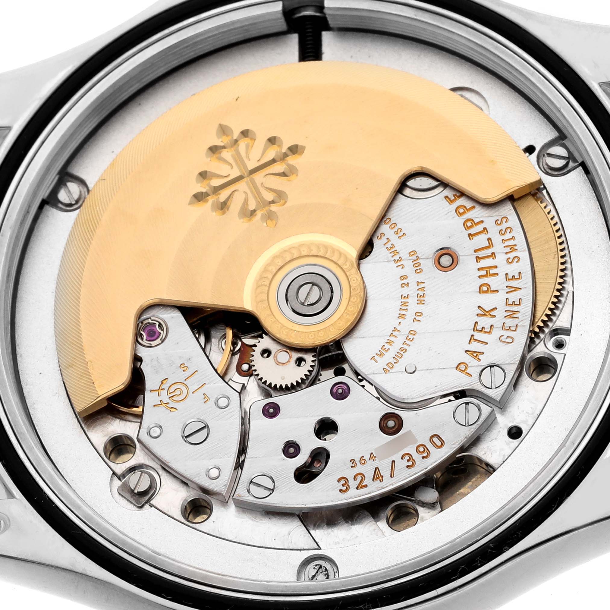 The image shows the movement of a Patek Philippe Calatrava 5108G-012 Men
s White Gold White Dial 5108G-012 Men
s White Gold White Dial watch, highlighting its intricate mechanics and rotor.