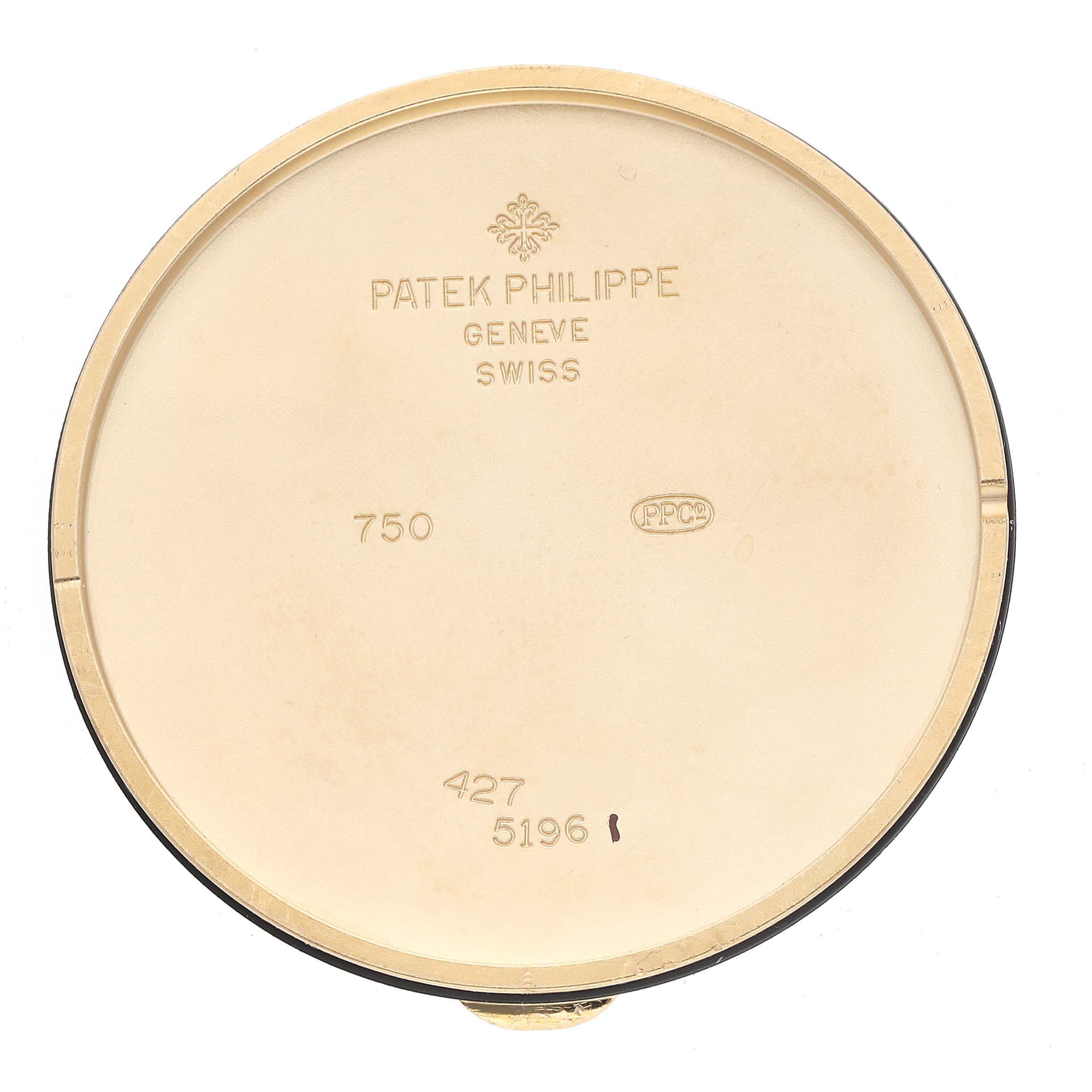 This image shows the inside of a case back for the Patek Philippe Calatrava 5196J Men's Yellow Gold Silver Dial watch, displaying engravings and stamps.