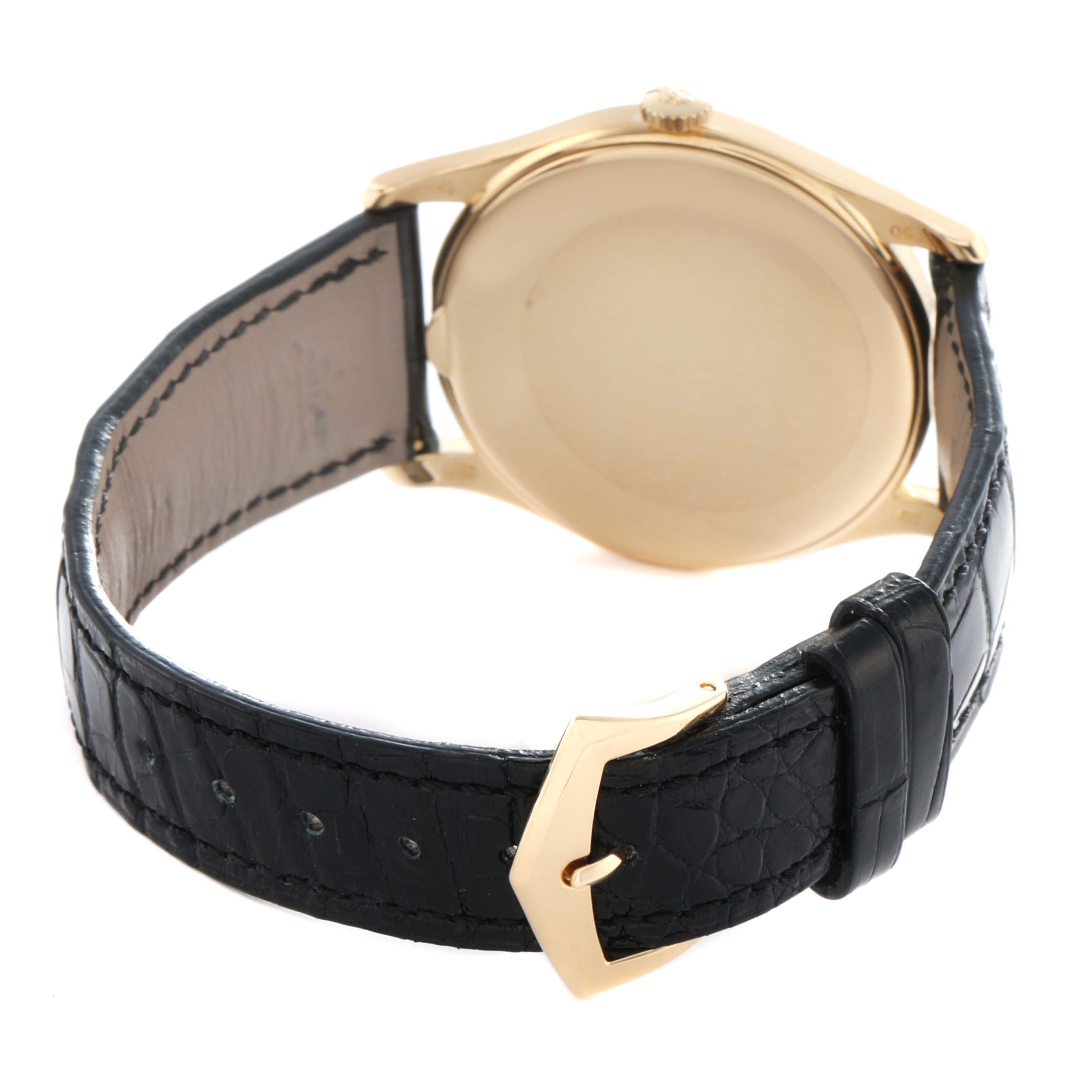 The image shows the back of a Patek Philippe Calatrava 5196J Men's Yellow Gold Silver Dial watch, highlighting the case back, crown, and leather strap with a buckle.