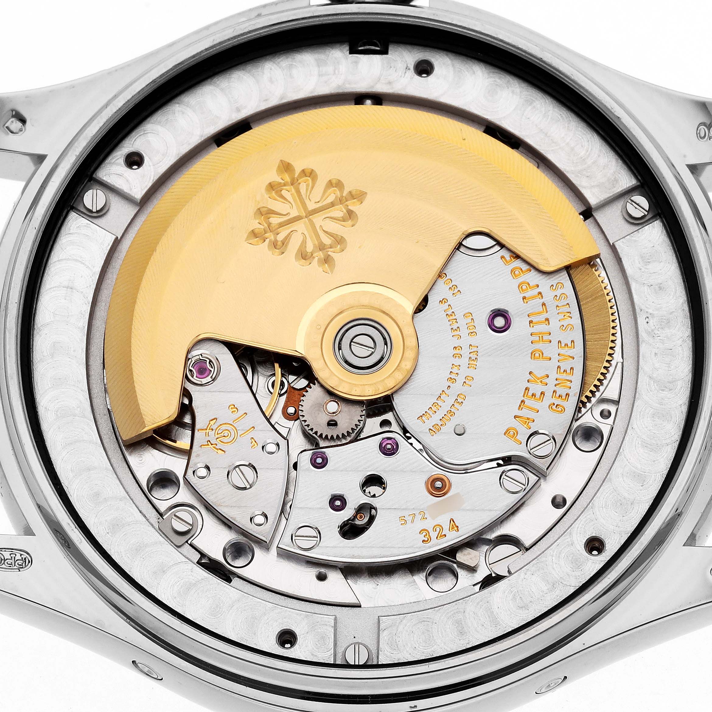 The image shows the back view of a Patek Philippe Complications 5146G Men
s White Gold White Dial watch, highlighting its rotor and intricate movement.