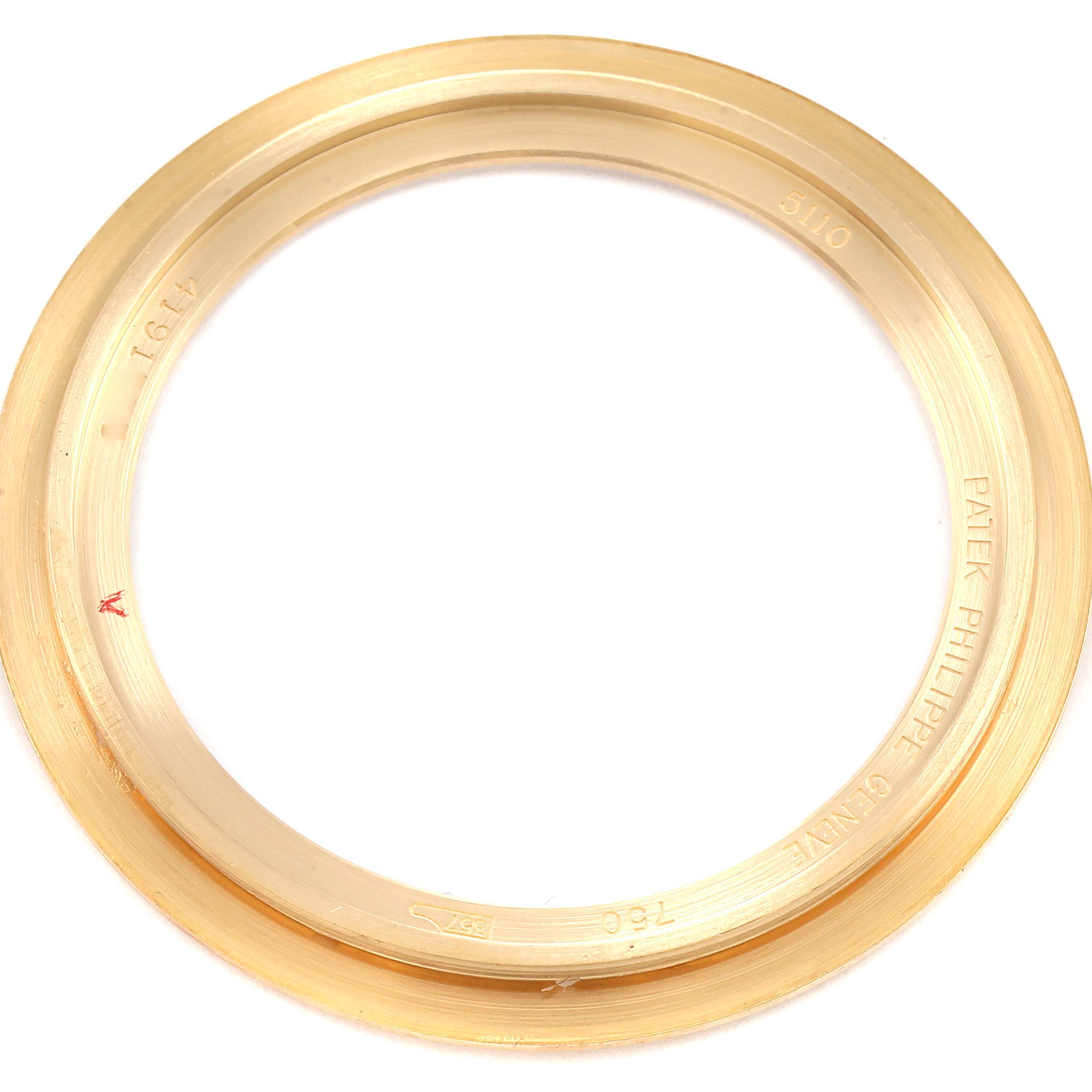 This image shows a close-up of the bezel for a Patek Philippe Complications 5110J Men's Yellow Gold Silver Dial 5110J Men's Yellow Gold Silver Dial model.