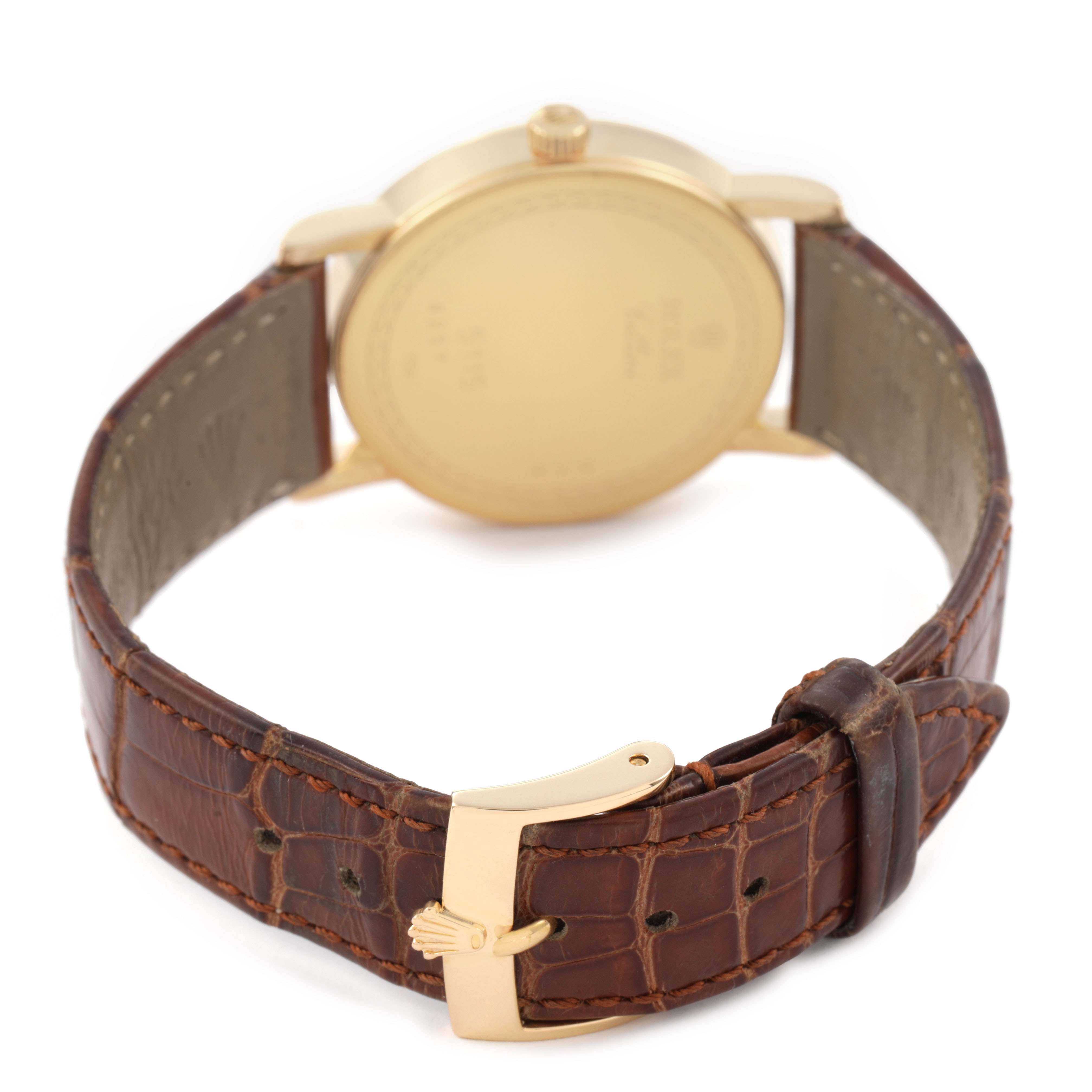 The Rolex Cellini 5115/8 Men's Yellow Gold Mother of Pearl Dial watch is shown from the back, highlighting the gold case, brown leather strap, and gold clasp.