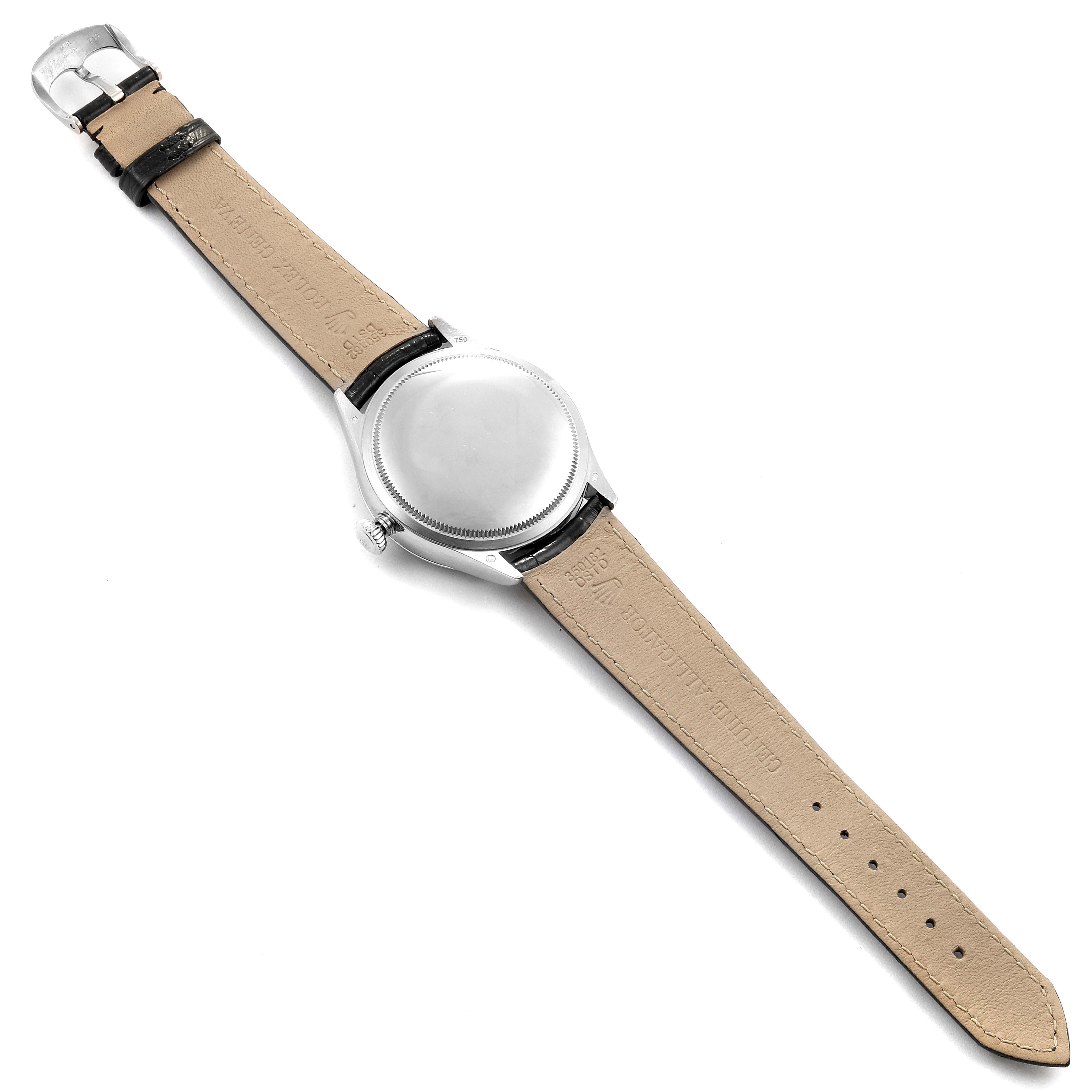 The image shows the back view of a Cellini model Rolex watch, including its leather strap and buckle.