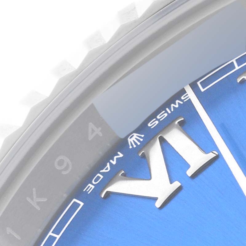 The image shows a close-up of the Roman numeral "VI," part of the dial, and the rehaut of a Rolex Datejust 41 126334 Men
s Stainless Steel Blue Dial 126334 Men
s Stainless Steel Blue Dial watch.