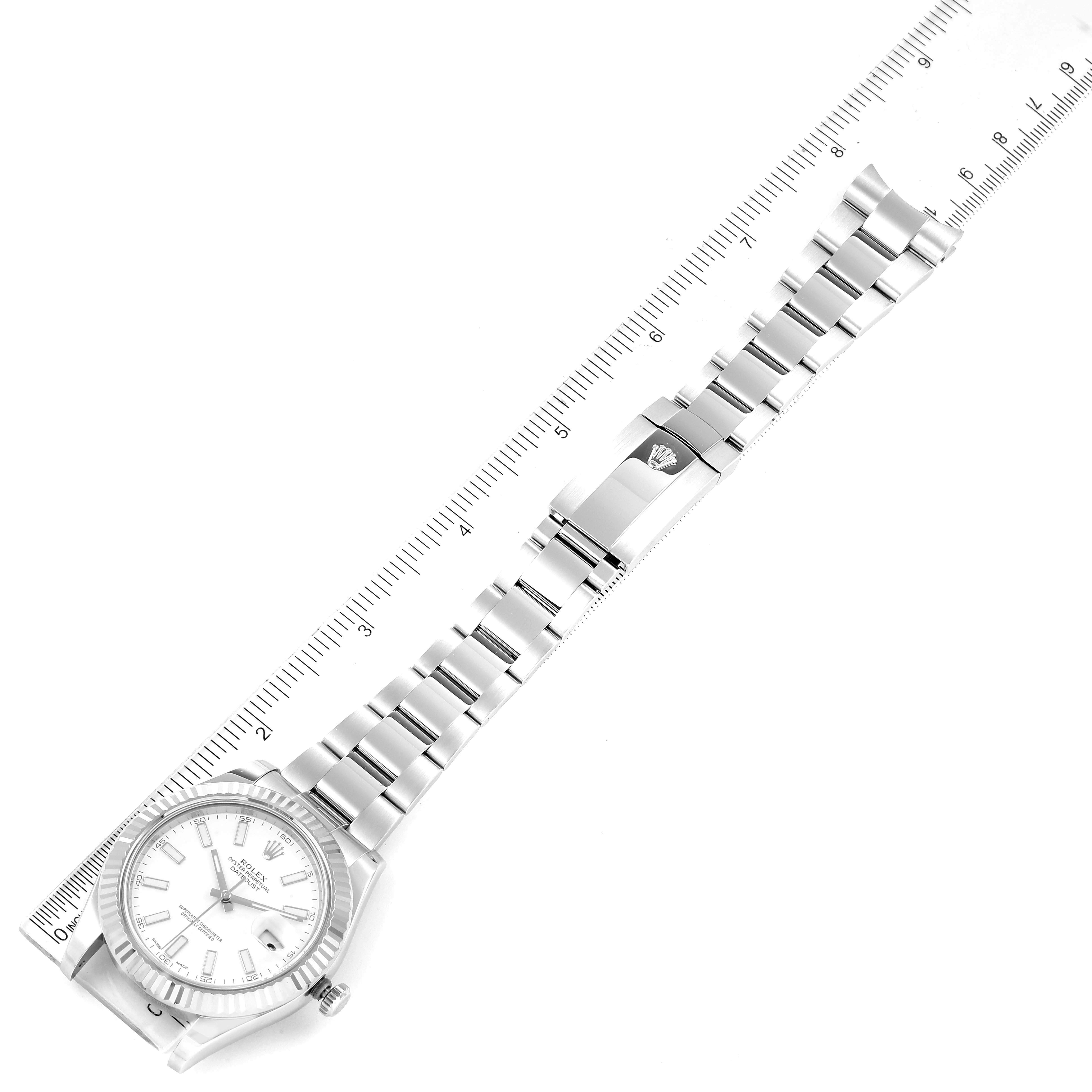 This image shows the full length of the Rolex Datejust 41 116334 Men's Stainless Steel White Dial 116334 Men's Stainless Steel White Dial watch with its band, laid alongside a ruler for scale.