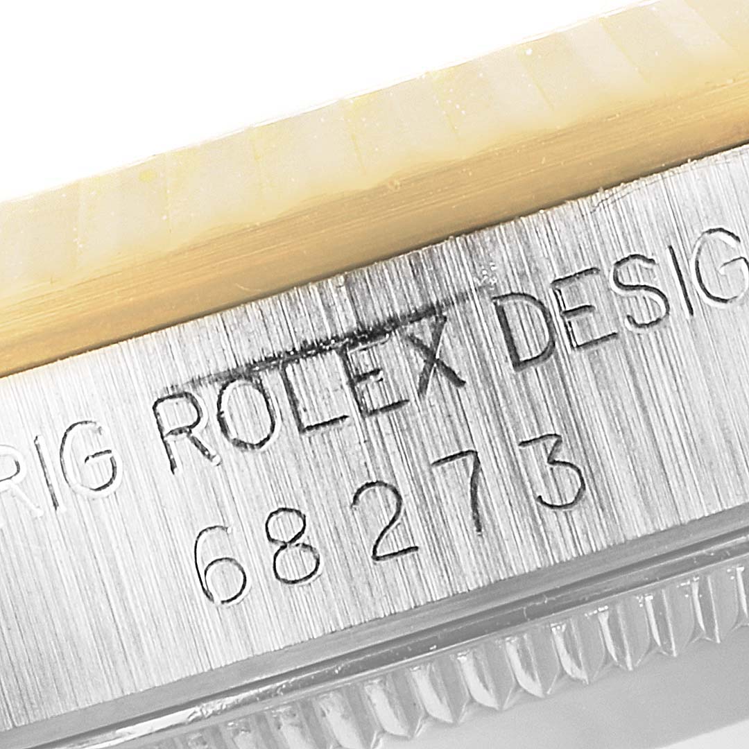 The image shows an up-close view of the case side and serial number of a Mid-Size Rolex watch.