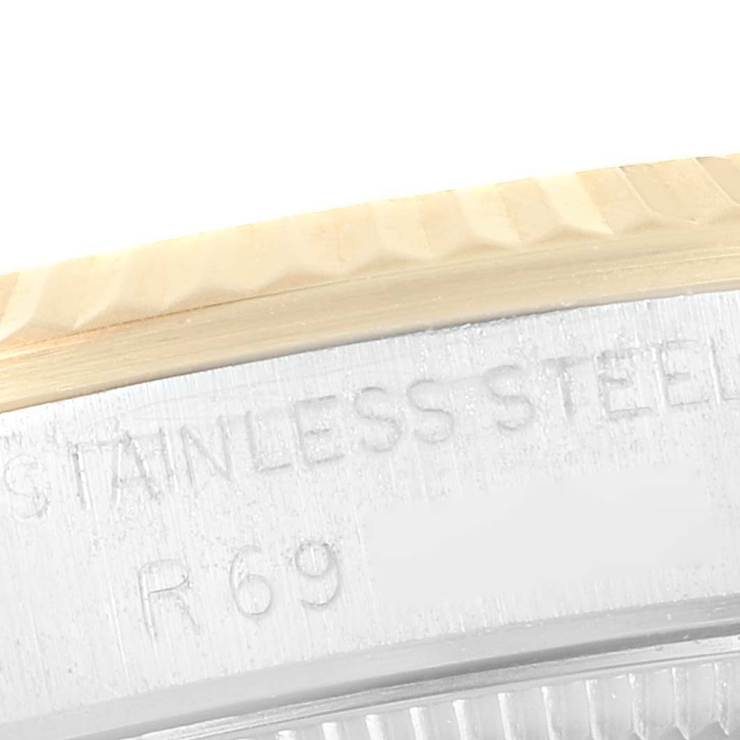 The image shows a close-up of the side casing with engravings on a Mid-Size Rolex watch.