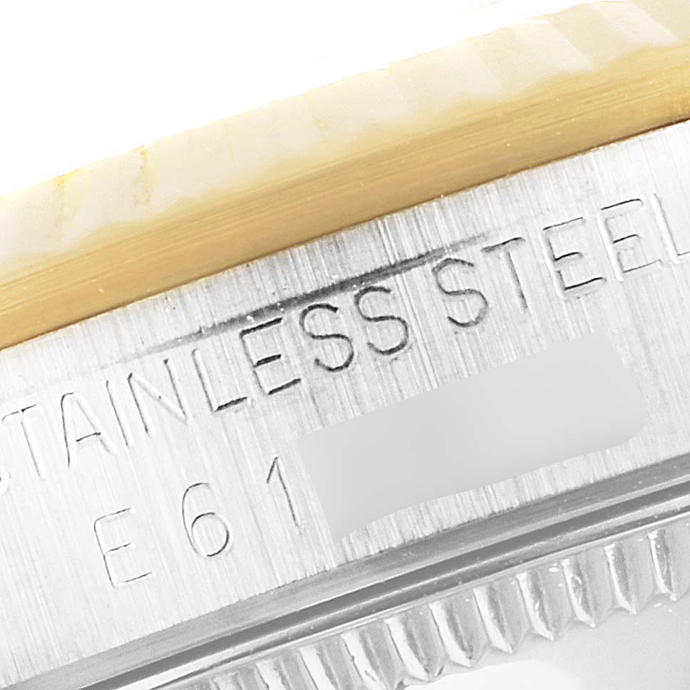 The image shows a close-up of the bezel and "STAINLESS STEEL" engraving on a Mid-Size Rolex watch.