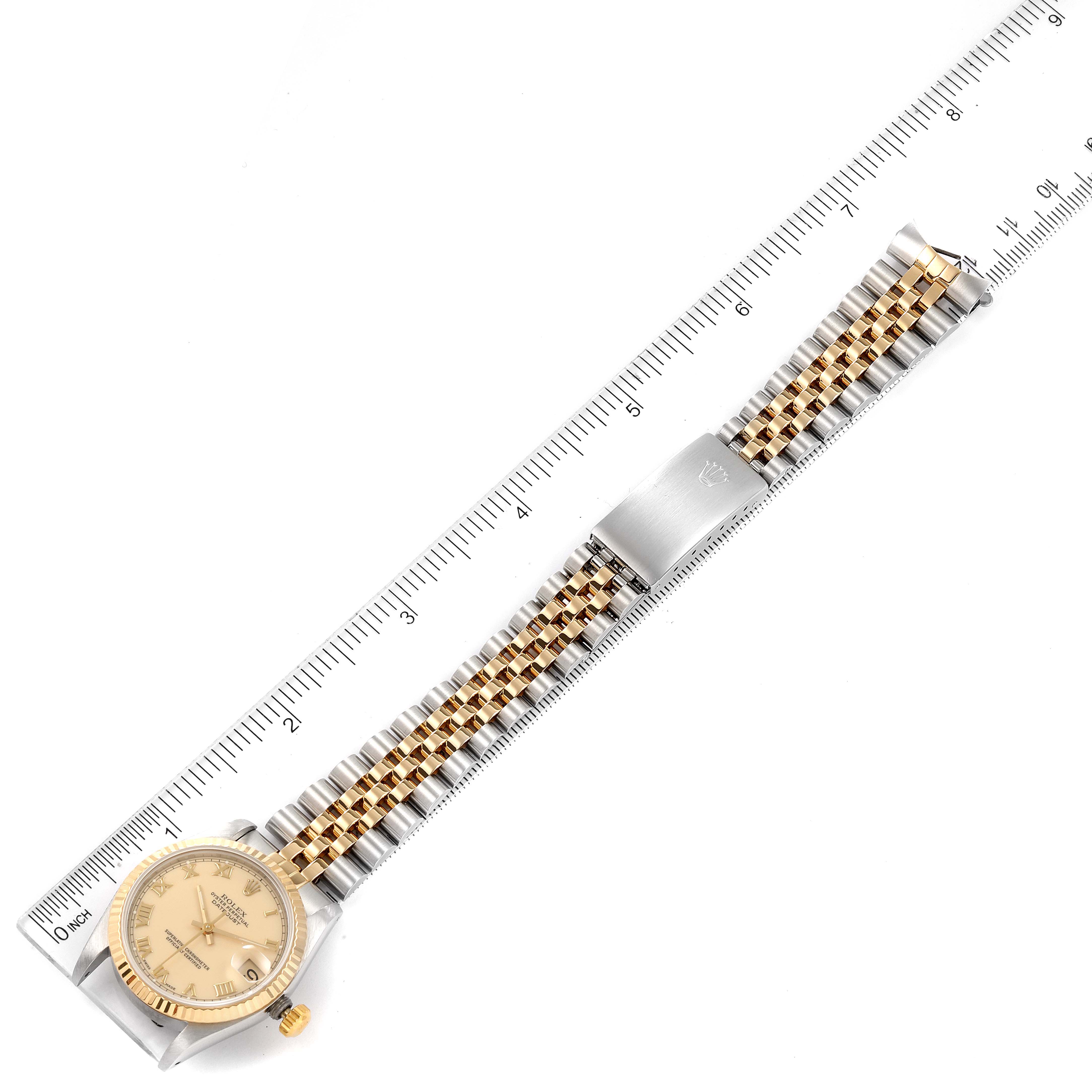The image shows a Rolex Mid-Size 68273 Women's Steel and Gold (two tone) Beige Dial 68273 Women's Steel and Gold (two tone) Beige Dial watch laid flat next to a ruler, displaying its entire band and face from a top-down perspective.