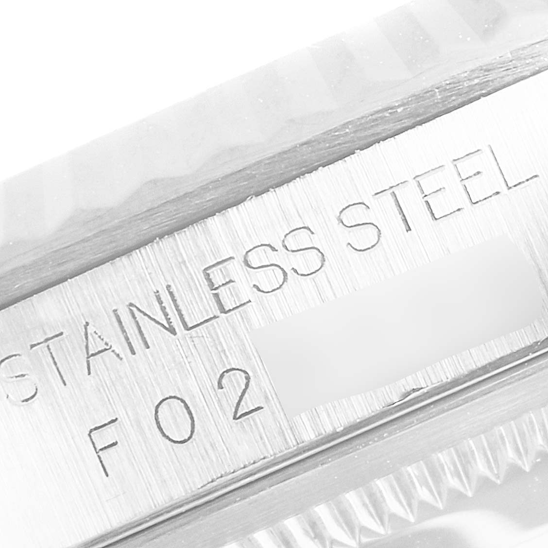 This is a close-up image of the engraved section on the case of a Rolex Datejust 16234 Men's Stainless Steel Silver Dial 16234 Men's Stainless Steel Silver Dial watch showing the words "STAINLESS STEEL."