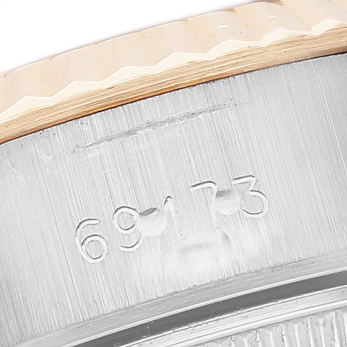 The image shows a close-up of the model number engraving on the side of a Rolex Datejust 69173 Women's Yellow Gold Black Dial watch case.