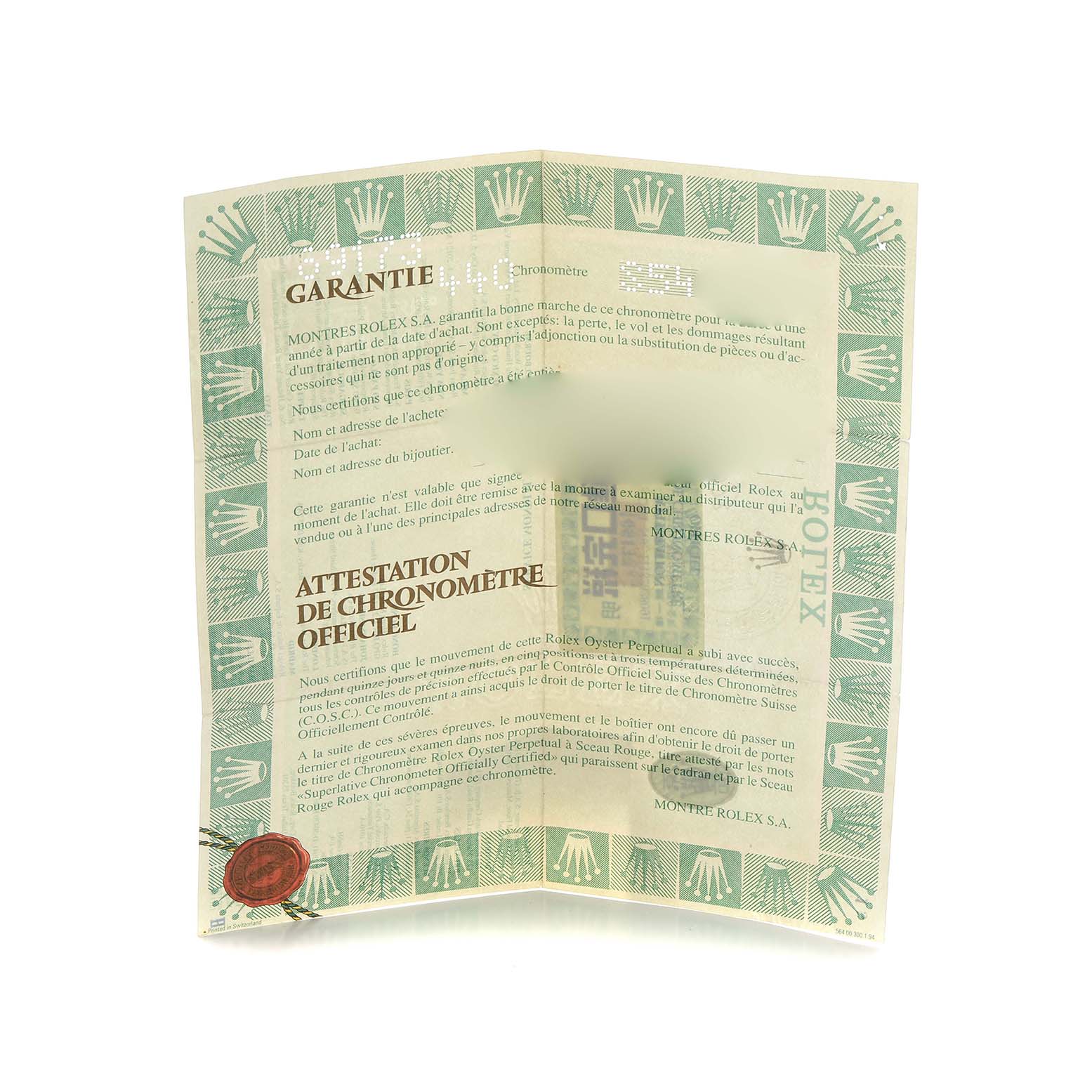 The image shows a Rolex Datejust 69173 Women
s Steel and Gold (two tone) Champagne Dial warranty certificate from a top-down angle, with text and a logo prominently displayed.