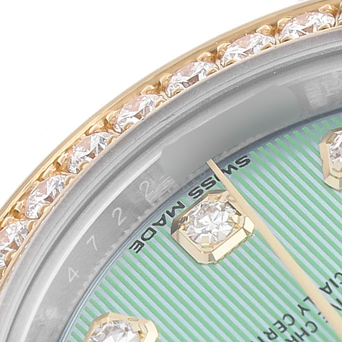 The image shows a partial view of the Rolex Datejust 279383 Women's Steel and Gold (two tone) Green Dial's diamond bezel and dial, focusing on the "Swiss Made" text.