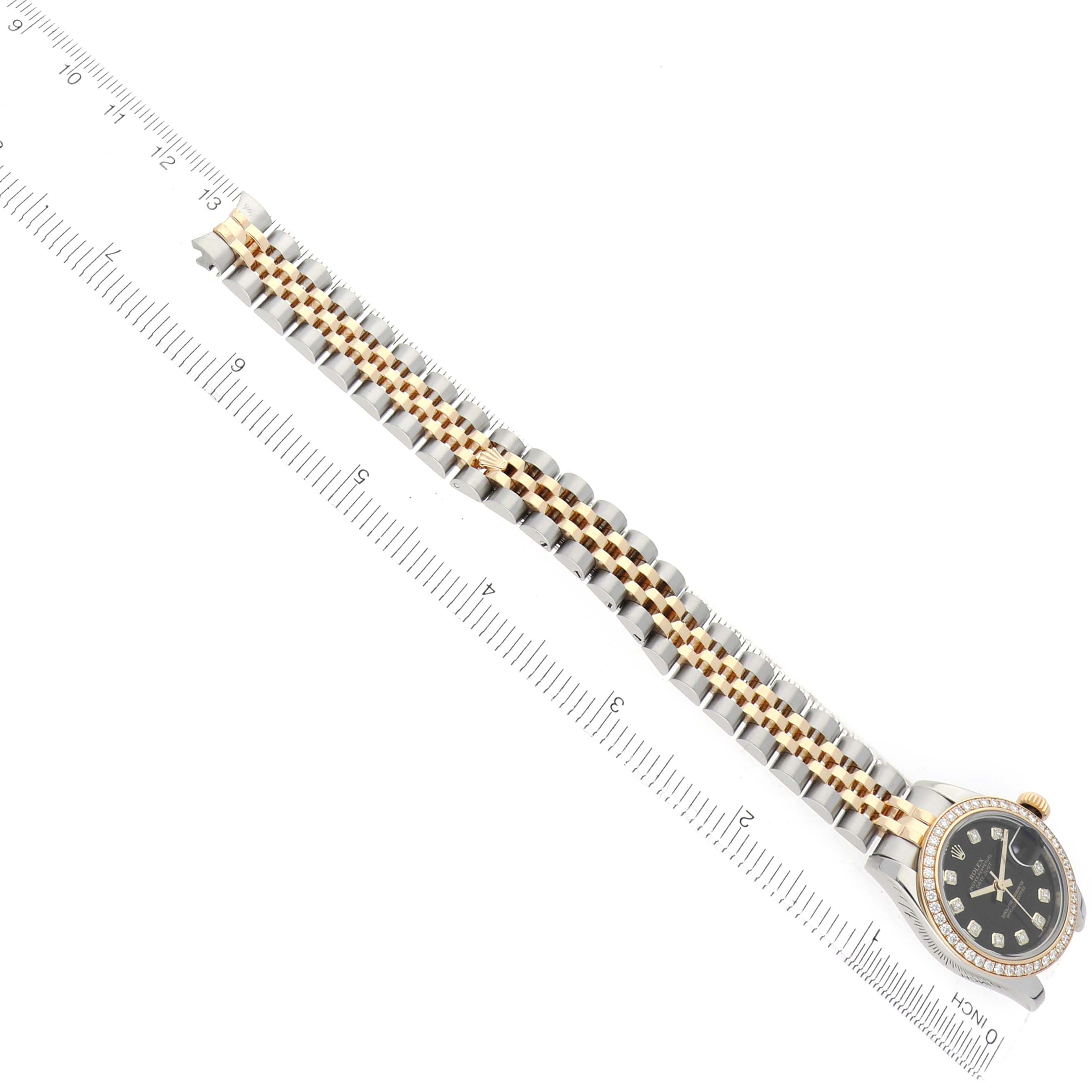 The Rolex Datejust 179383 Women
s Steel and Gold (two tone) Black Dial watch is shown from a top view, featuring the bracelet and partial view of the watch face and bezel.