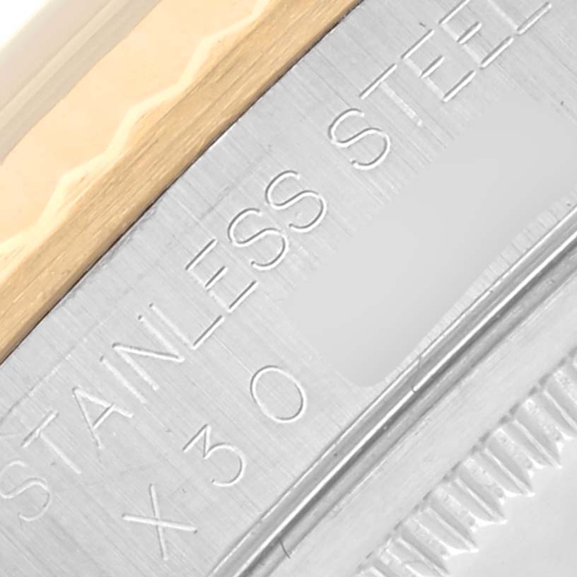 The image shows a close-up of the engraved bezel edge and side of a Rolex Datejust 16233 Men
s Steel and Gold (two tone) White Dial 16233 Men
s Steel and Gold (two tone) White Dial, highlighting "STAINLESS STEEL."