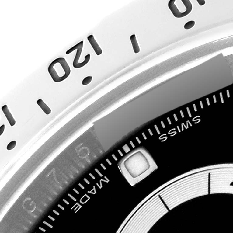 This image shows a close-up of the bezel and dial of a Rolex Daytona 116520 Men
s Stainless Steel Black Dial 116520 Men
s Stainless Steel Black Dial watch, featuring part of the tachymeter scale.