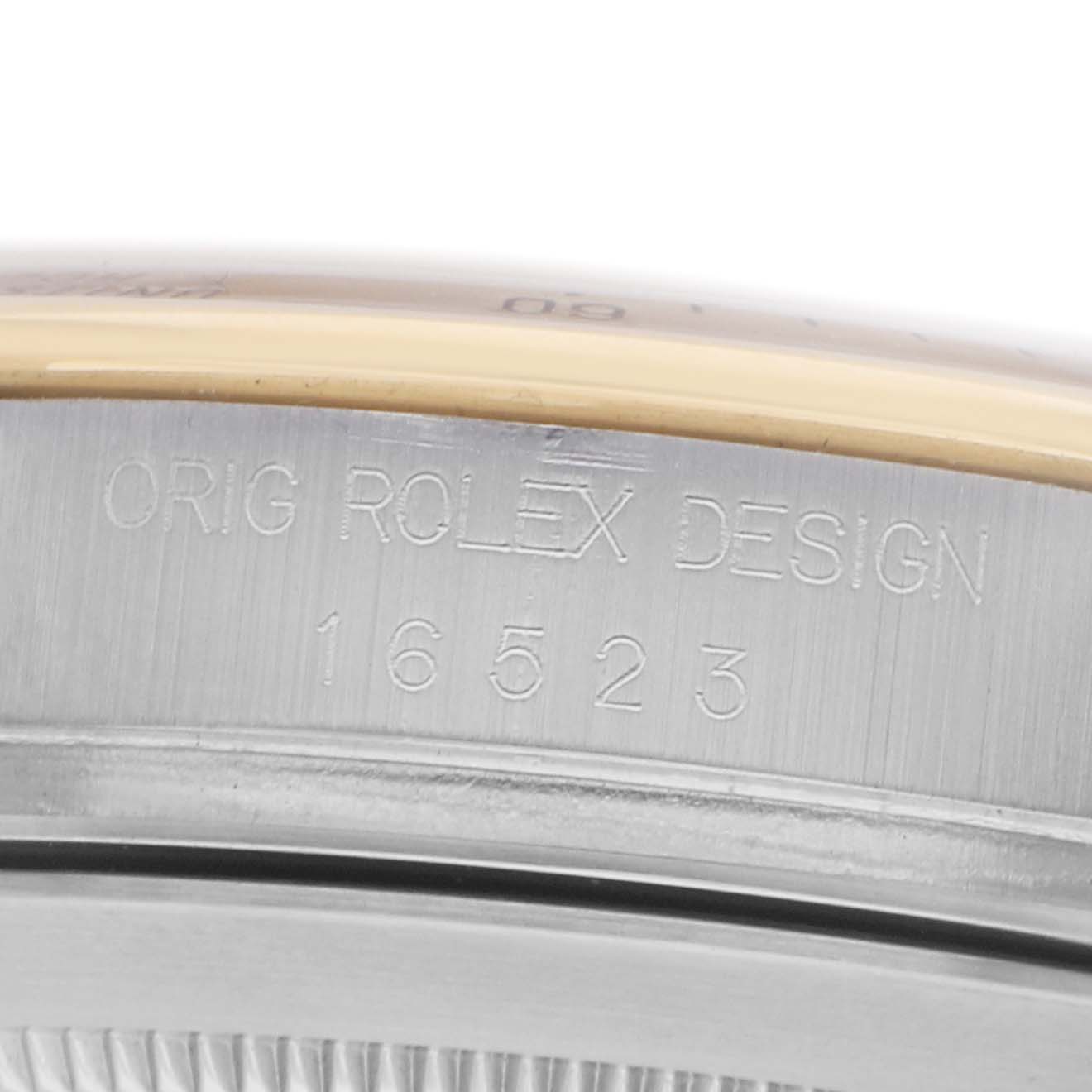 The image shows a close-up of the Rolex Daytona 16523 Men
s Steel and Gold (two tone) Champagne Dial
s case side with model number engraving.