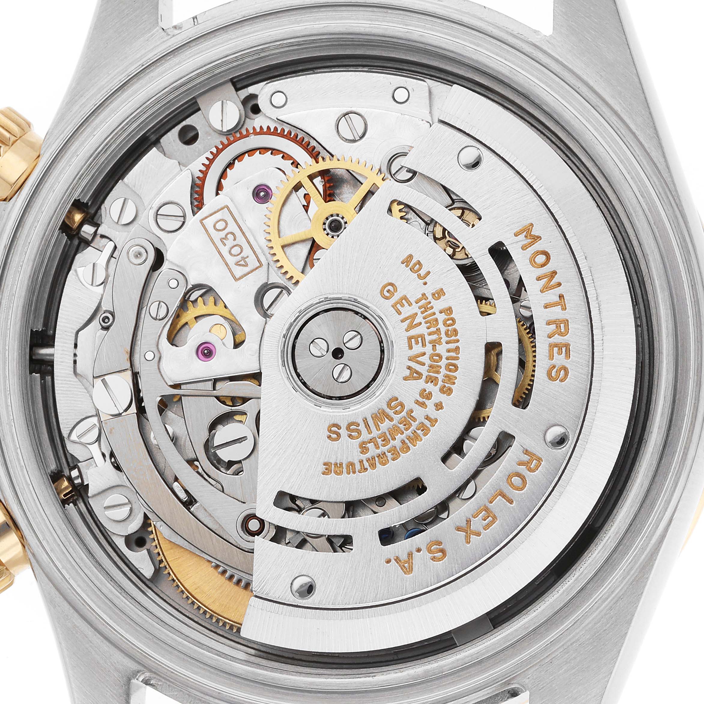 The image shows the back view of a Rolex Daytona 16523 Men
s Steel and Gold (two tone) Champagne Dial, displaying its intricate movement and internal mechanics.