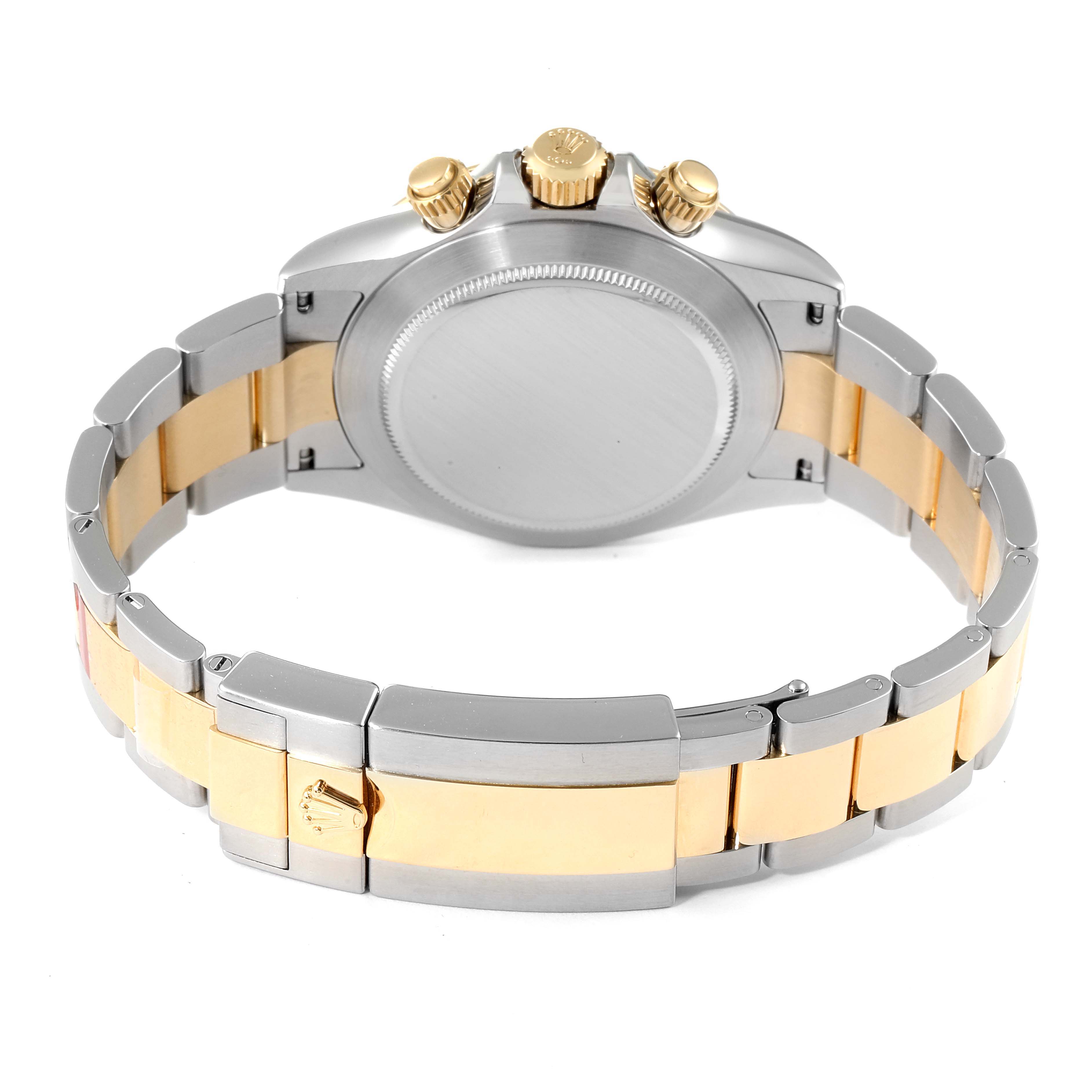 This Rolex Daytona 116503 Men's Steel and Gold (two tone) Mother of Pearl Dial 116503 Men's Steel and Gold (two tone) Mother of Pearl Dial watch is shown from the back, displaying its case, crown, pushers, and two-tone bracelet.