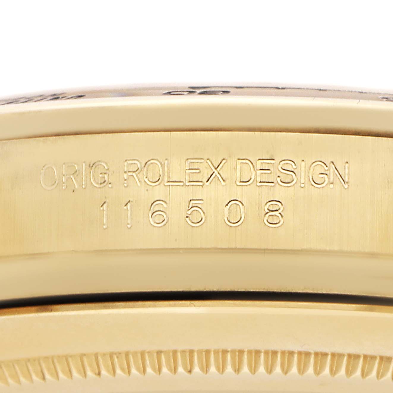 The image shows a close-up of the side of a Rolex Daytona 116508 Men
s Yellow Gold Champagne Dial case with the model number engraved.